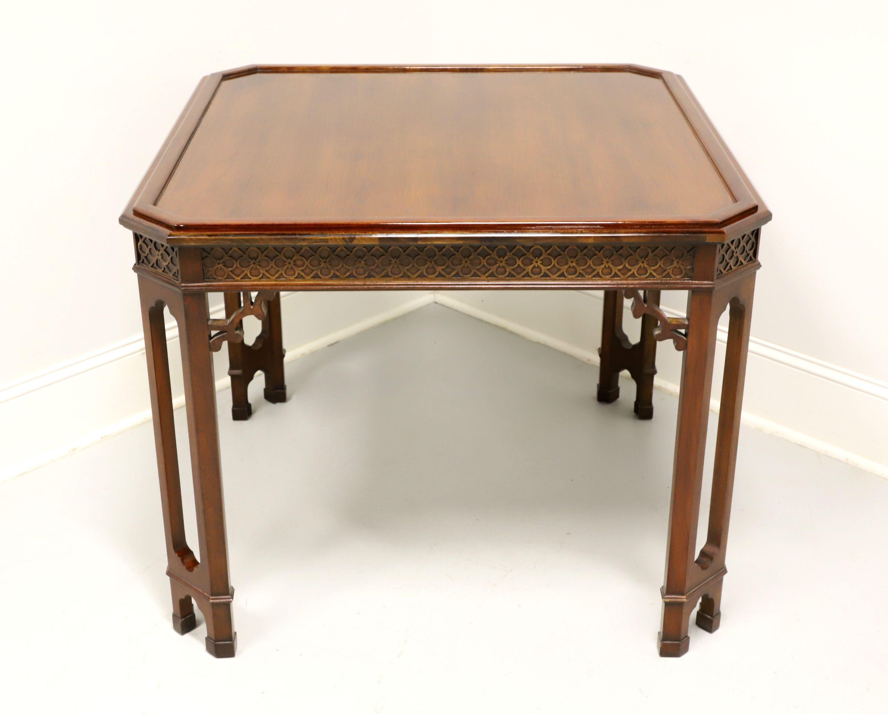 A Chinese Chippendale style square game table, unbranded. Solid mahogany, raised edge around the top, clipped corners, decorative fretwork to apron, open carved legs and block feet. Features a smooth top with the raised edge and decorative fretwork