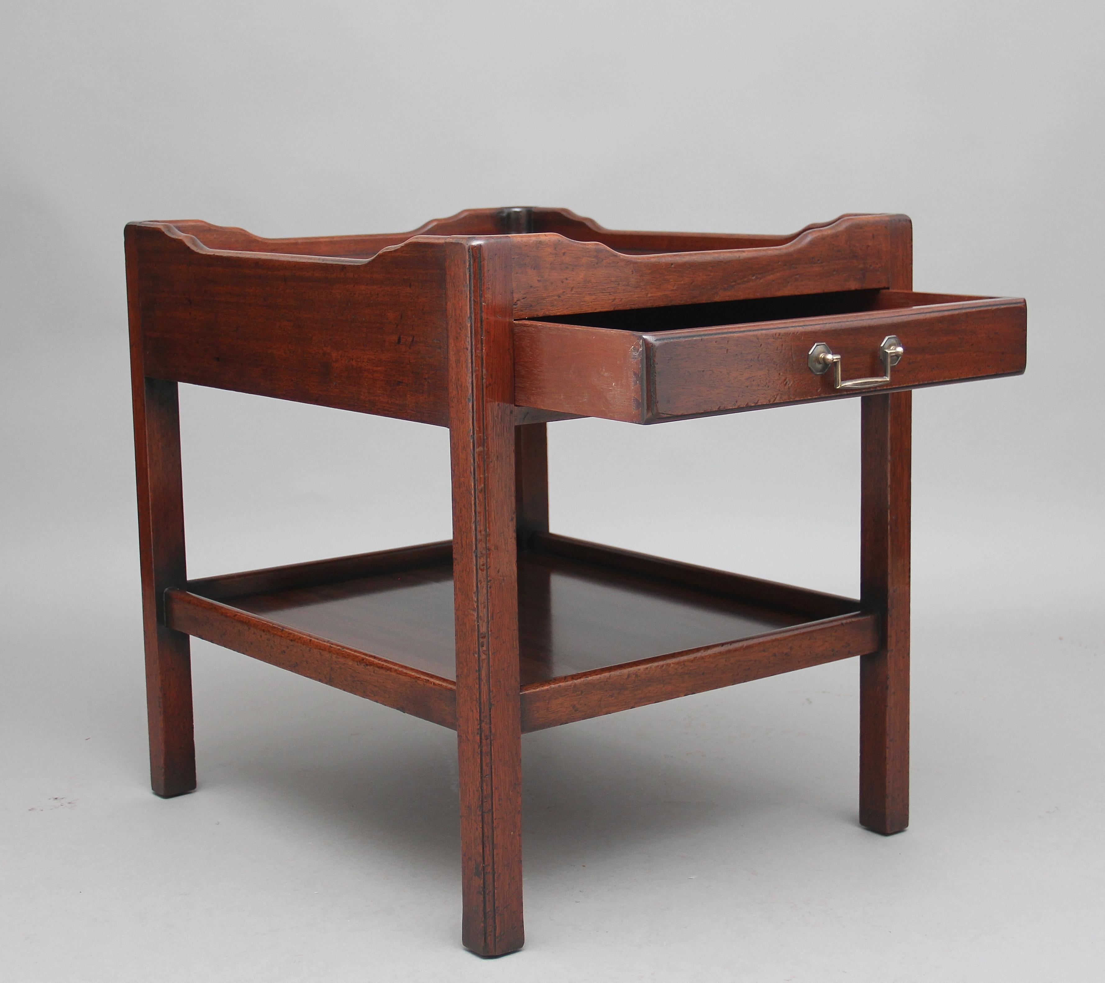 Mid-20th century mahogany occasional table, the top having a shaped gallery with a single mahogany lined drawer below, supported on square legs united with a shelf, circa 1960.

 
