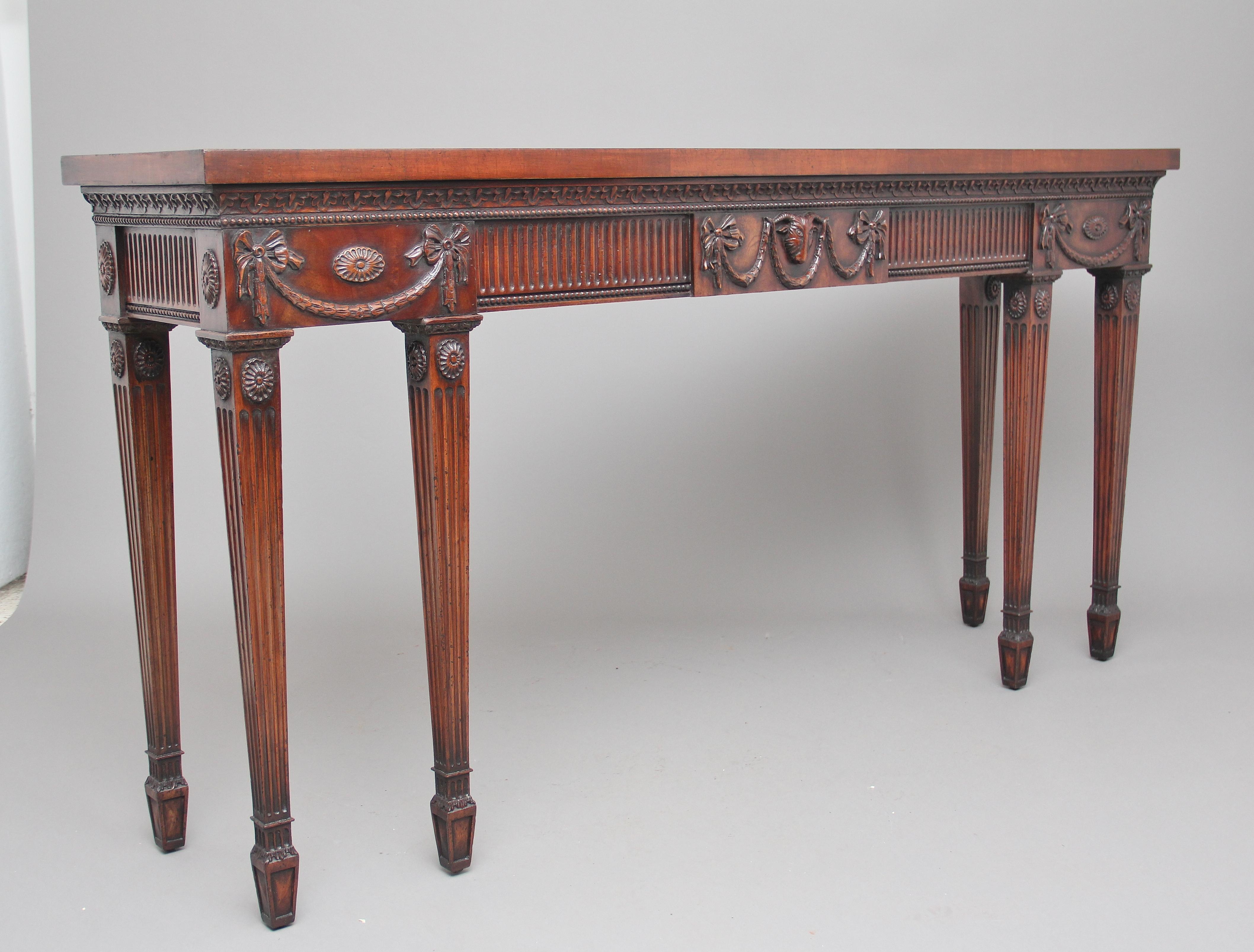 Mid-20th century mahogany serving table in the 18th century style of Robert Adam, the rectangular top above a profusely decorated frieze with lovely quality mouldings, patraes and swags, supported on six elegant fluted legs terminating on spade