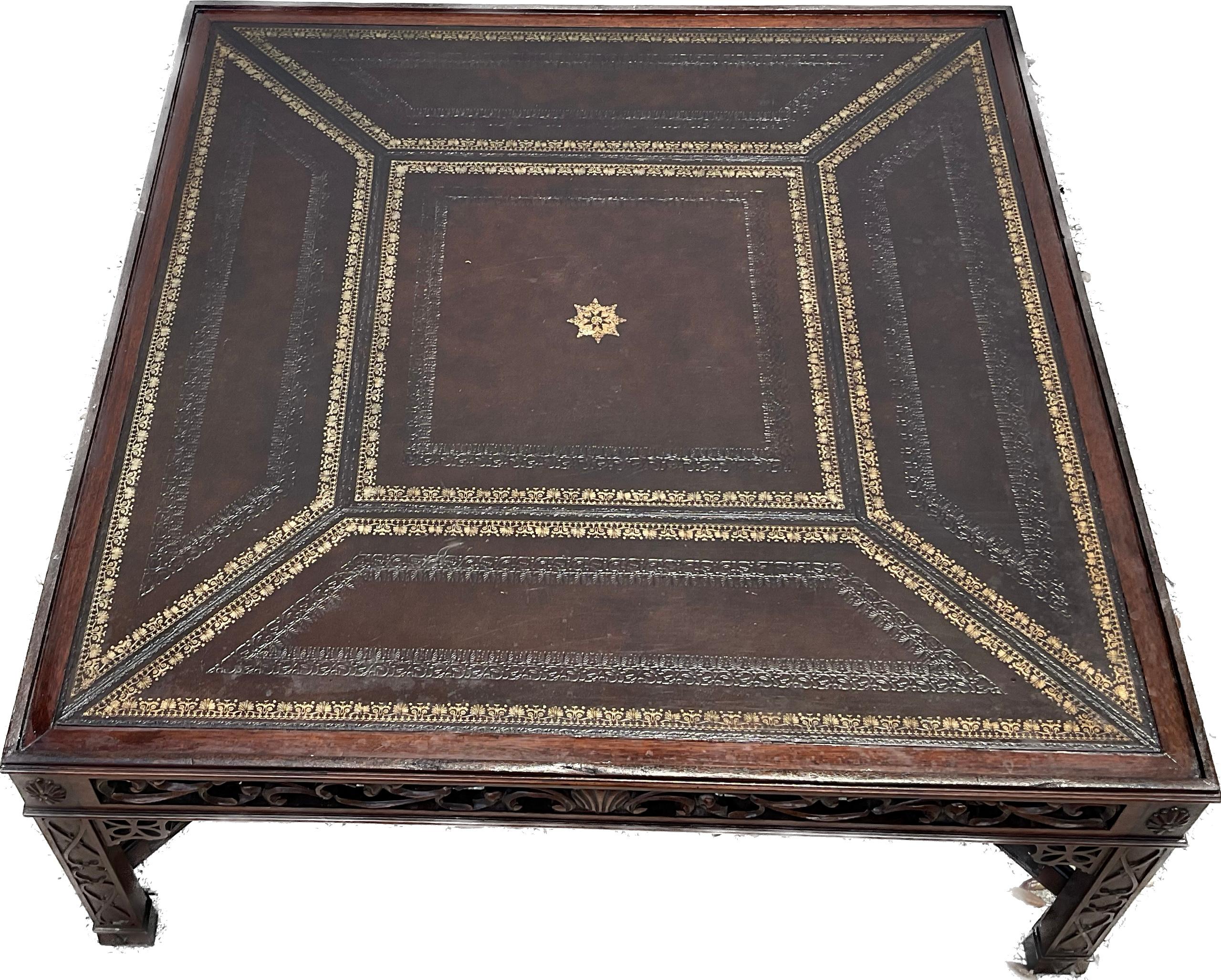 Large Maitland Smith mid-20th century Chinese Chippendale style square coffee table. Table has gold tooled leather inserts on top on beautifully carved and scrolled wood frame. Made in Philippines for Maitland-Smith stamp on inside bottom.  