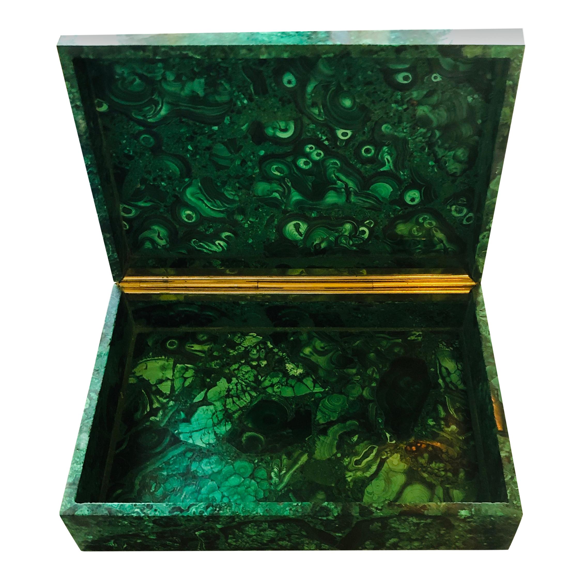 A mid-20th century polished malachite box with natural swirls and having an Ormolu hinge.