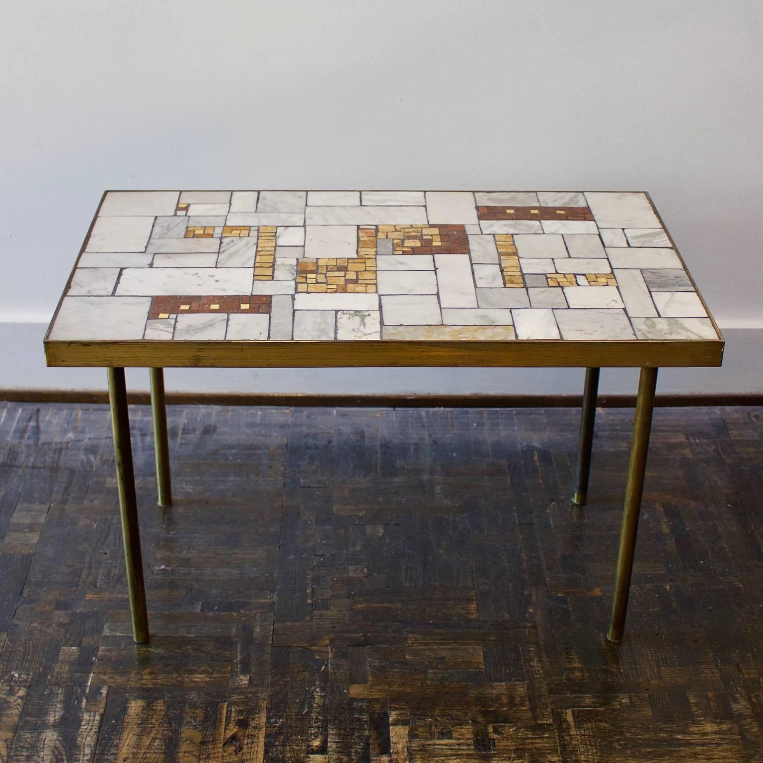 *** Please contact us for availability of this piece. ***

A marble and brass side table by Berthold Müller, Germany, mid-20th century.

The table is covered in tiles of marble, gold and yellow and red onyx on wood, with a brass or bronze surround.