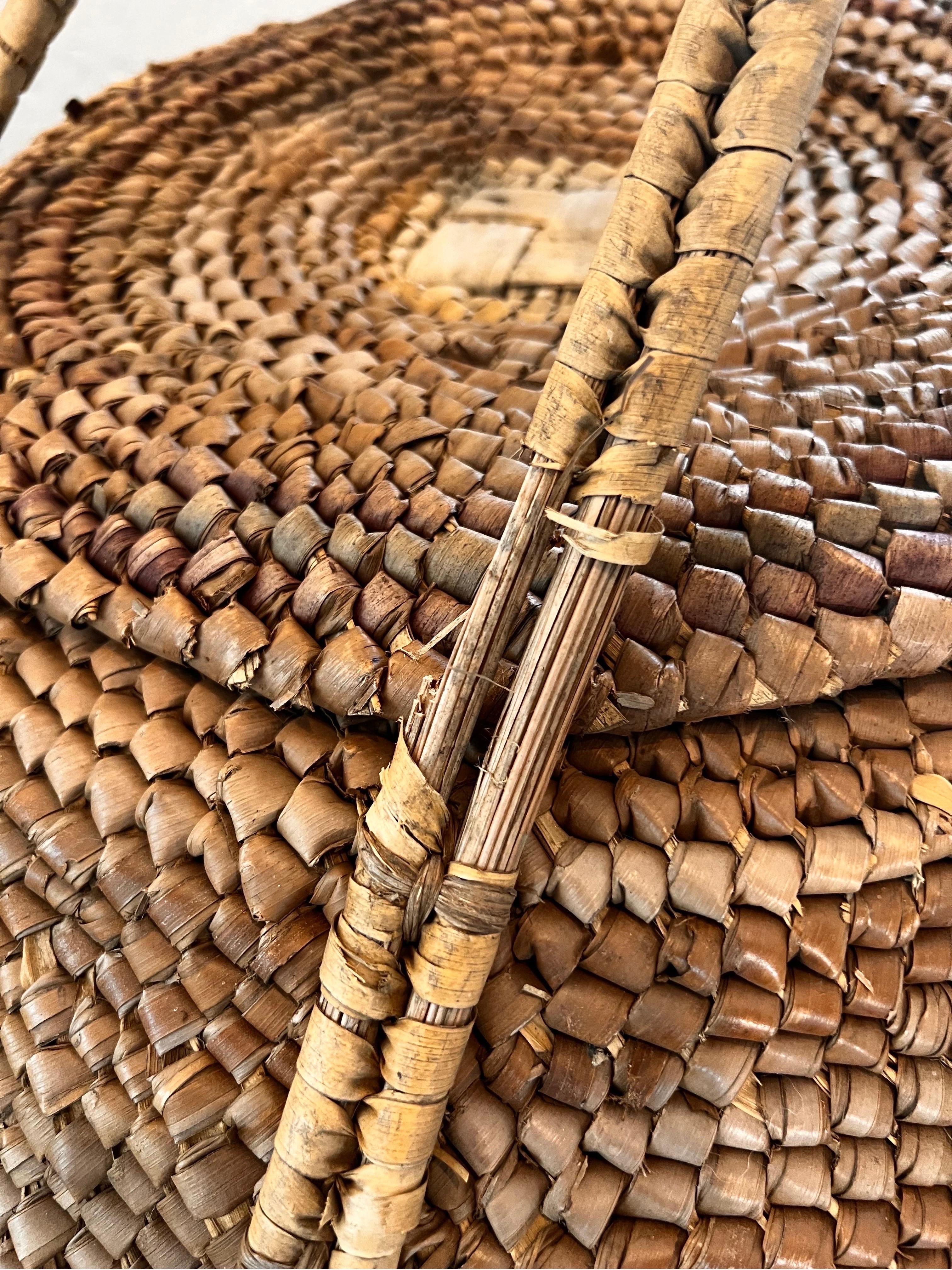 The Massive Mid 20th Century Basket was part of a collection of baskets found in the original basket weaving community where it was originally woven. The pieces had been woven by a weaving group who stored the pieces in a warehouse and left them,