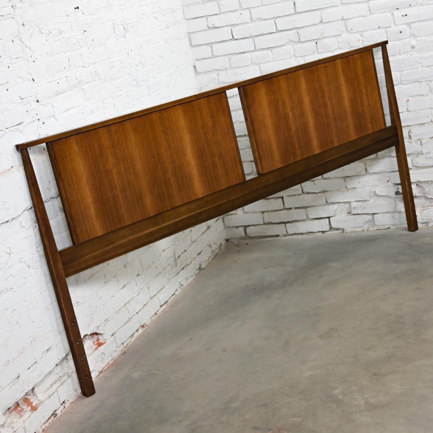 Handsome vintage Mid-Century Modern king sized double paneled walnut headboard. Beautiful original condition, keeping in mind that this is vintage and not new so will have signs of use and wear even if it has been refinished or restored. We have