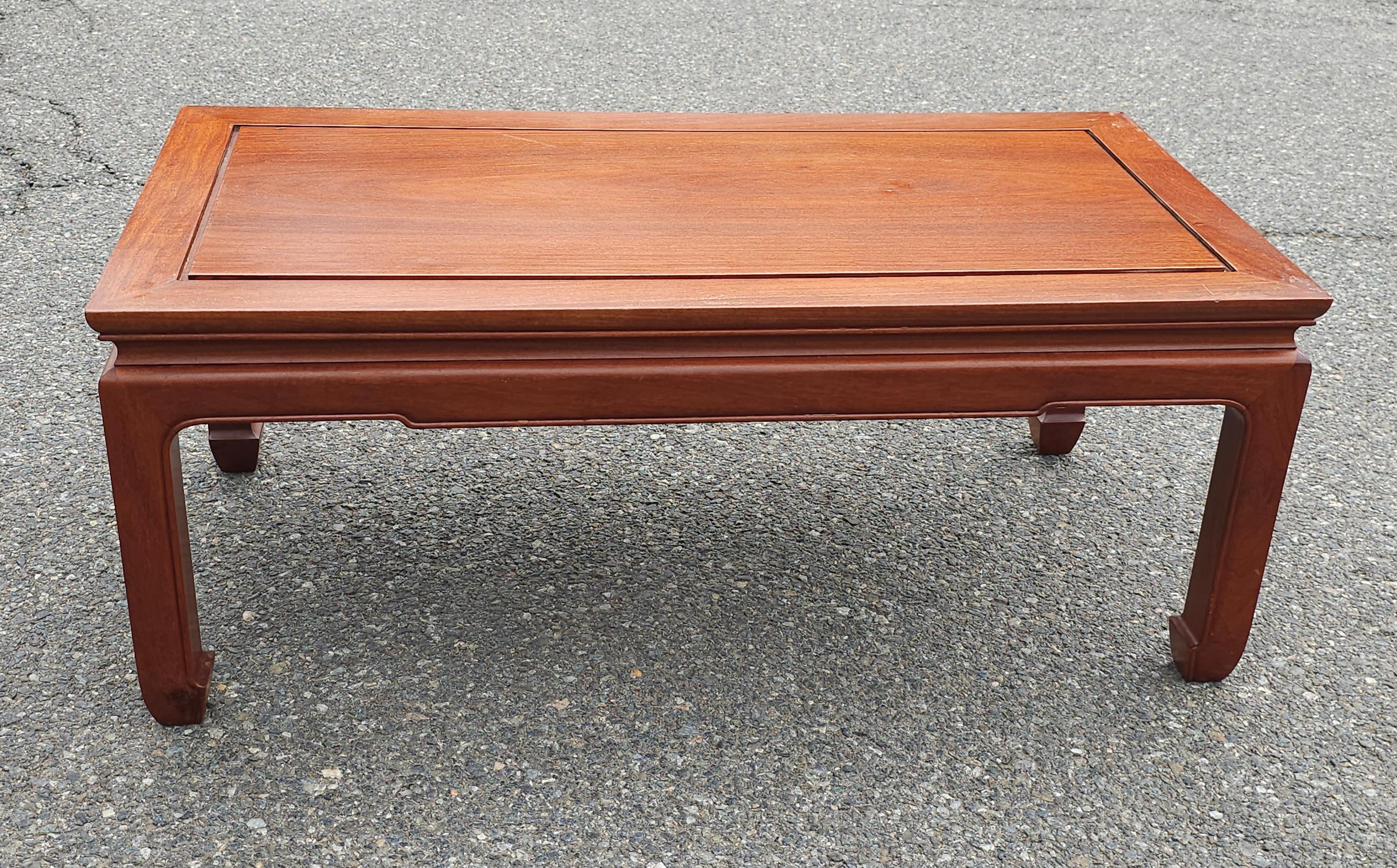 An exquisite Mid 20th Century Ming Style Rosewood cocktail  Table with protective Glass Top. Pristine vintage condition with very light signs of use.

Measures 40