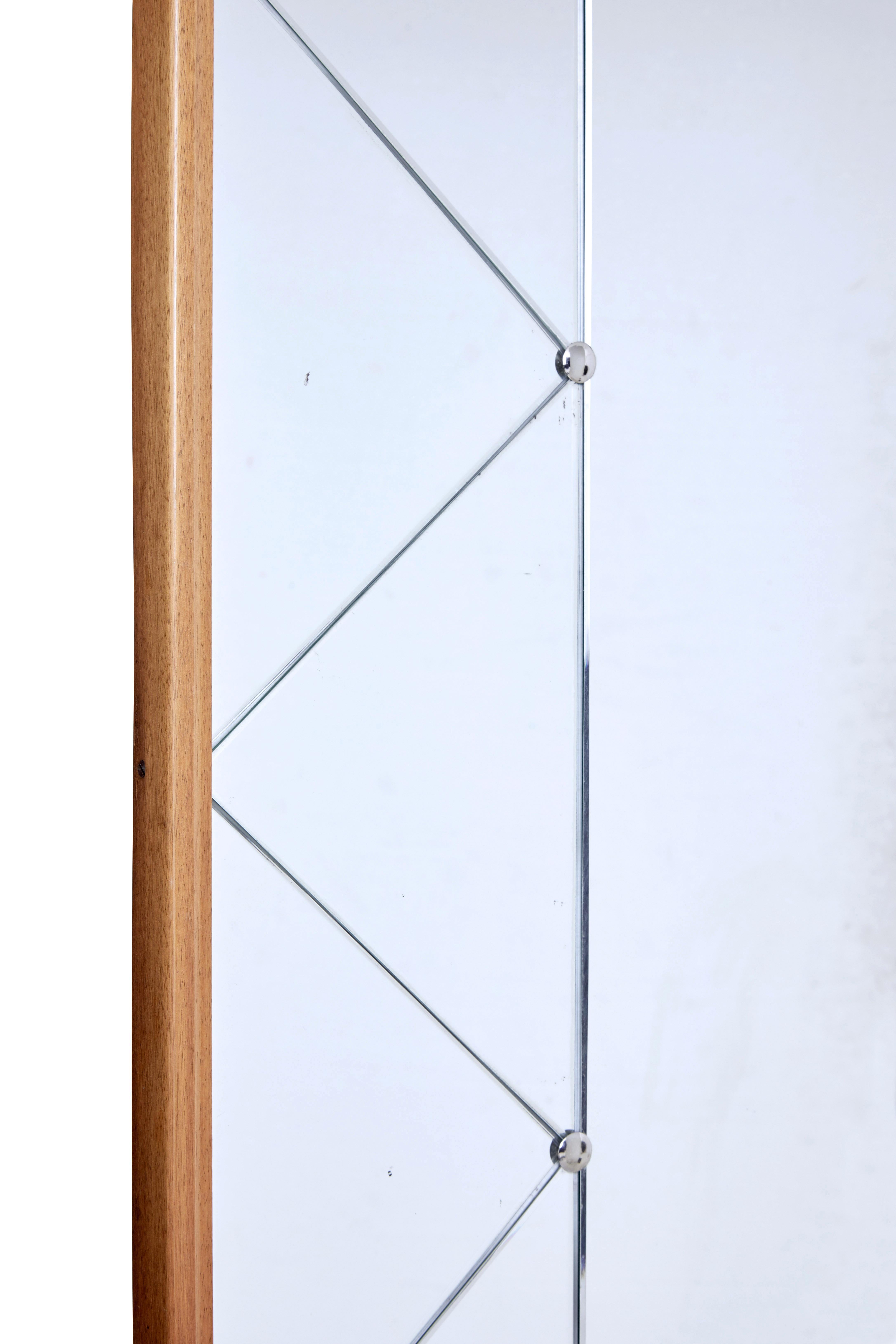 Mid-20th century mirror by G+T Hovmantorp, circa 1960.

Scandinavian Modern wall mirror by Swedish makers glas and tra. Moulded beech frame supports an arrangement of segments and central mirror, held in place by chrome screw in studs.

Minor