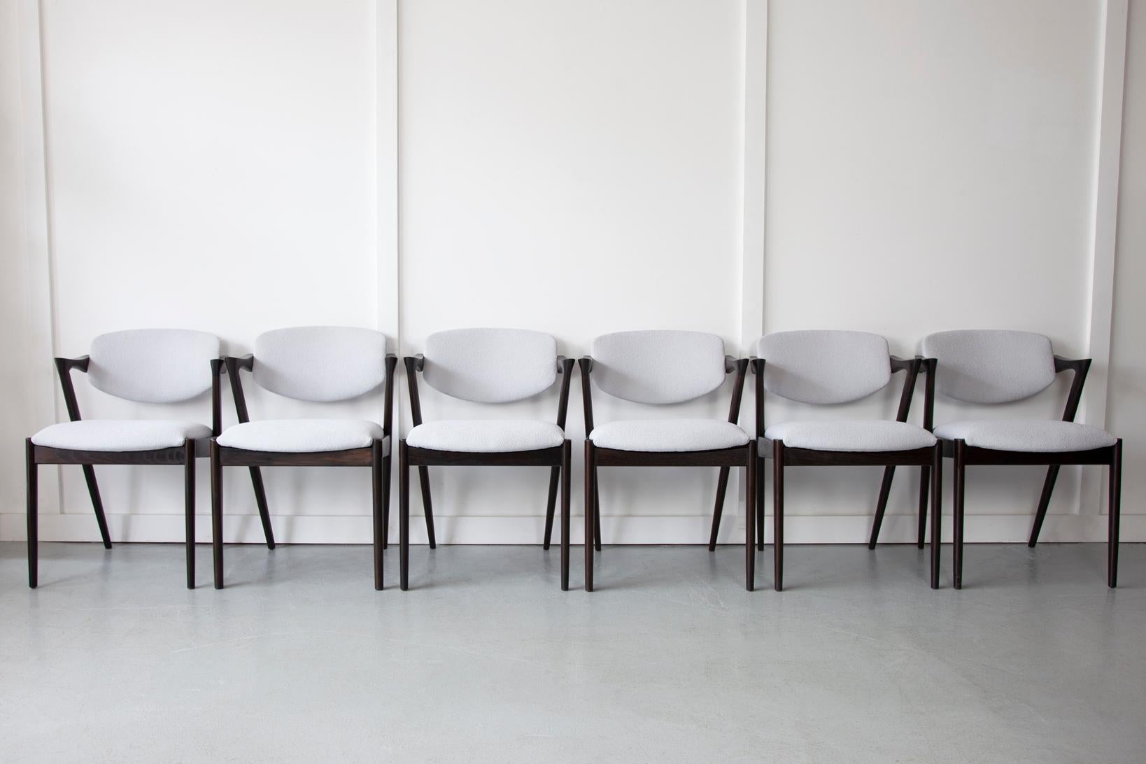 A set of original Kai Kristiansen Model 42 dining chairs produced by Schou Andersen. This iconic model are the most desired of all the chairs designed by this admired Danish designer, Kai Kristiansen. The chairs are very comfortable and supportive
