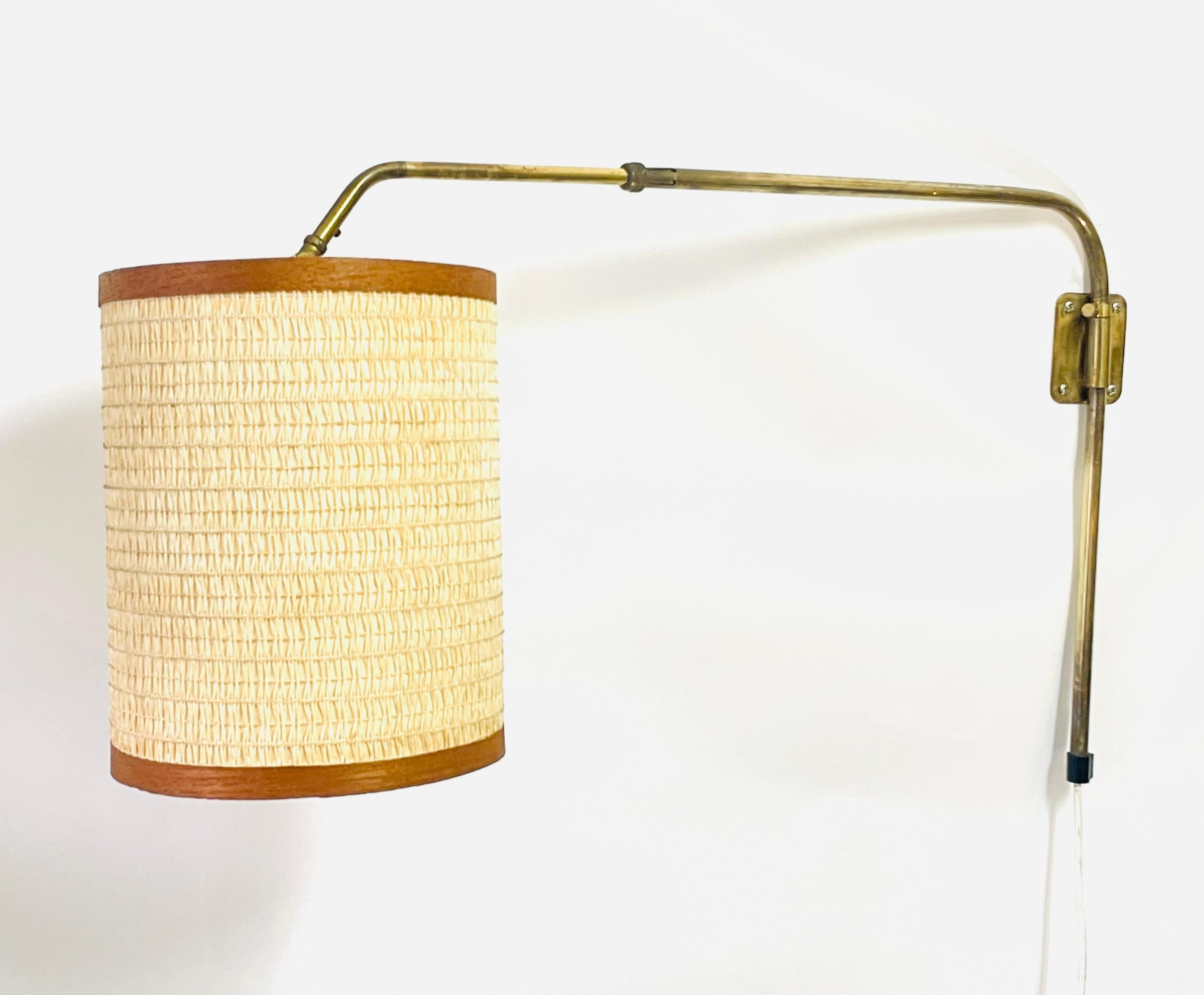Vintage 1950s Swedish Highly Adjustable Brass Wall Lamp with Teak decorations.

This elegant Swedish wall lamp from the 1950s embodies classic Scandinavian Mid-Century Modern design. Brass frame, the adjustable arm allows for versatile lighting