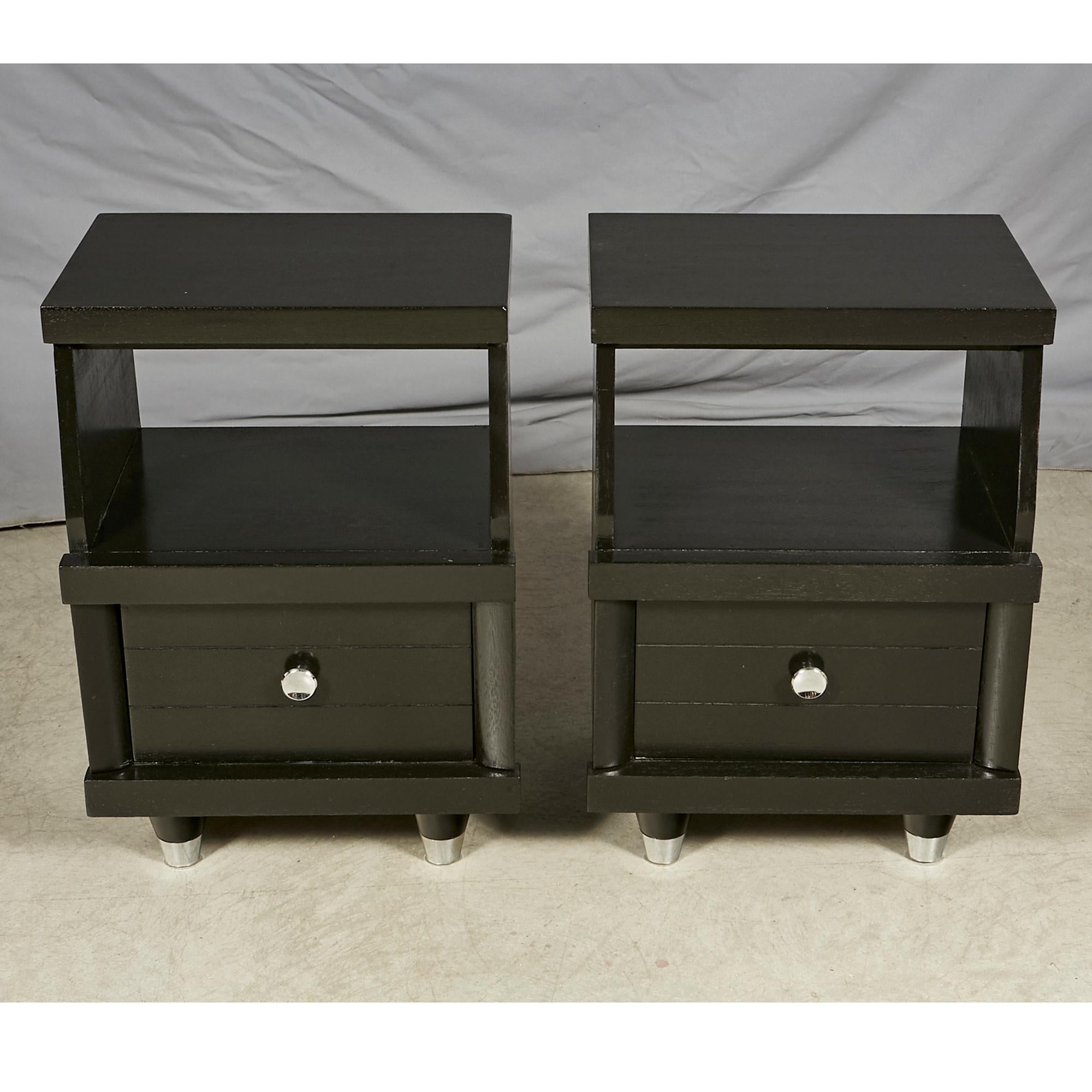 Vintage 1960s pair of black lacquered nightstands with a single drawer for storage. The nightstands have chrome metal accents. Newly refinished and in excellent condition.
      