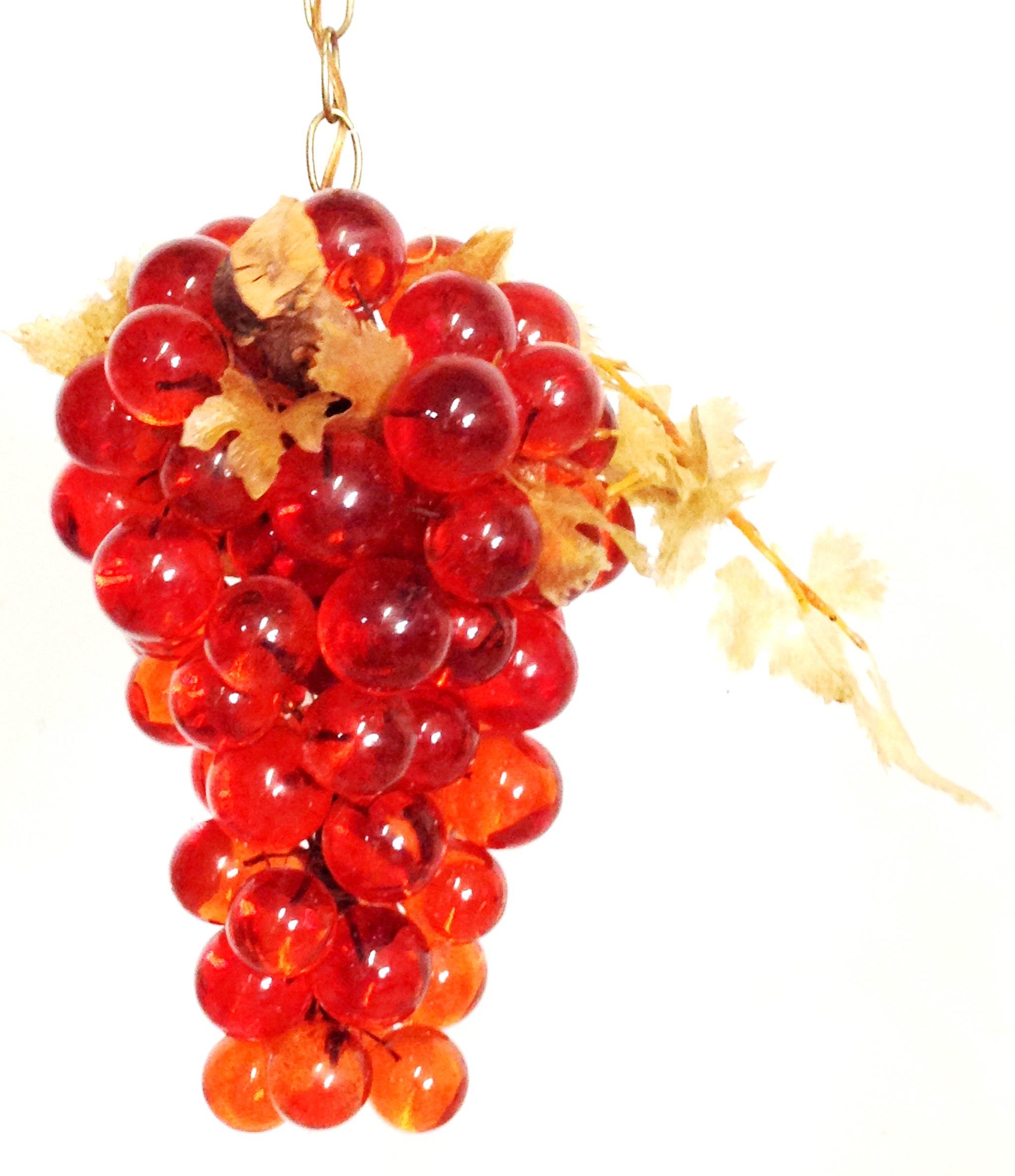 Mid-Century Modern Lucite and wood with plastic fauna and brass chain link grape bunch form hanging pendant light. Features, vivid orange Lucite balls, faux bois tree branch and foliage detail with brass chain link. Can hang straight or swag with