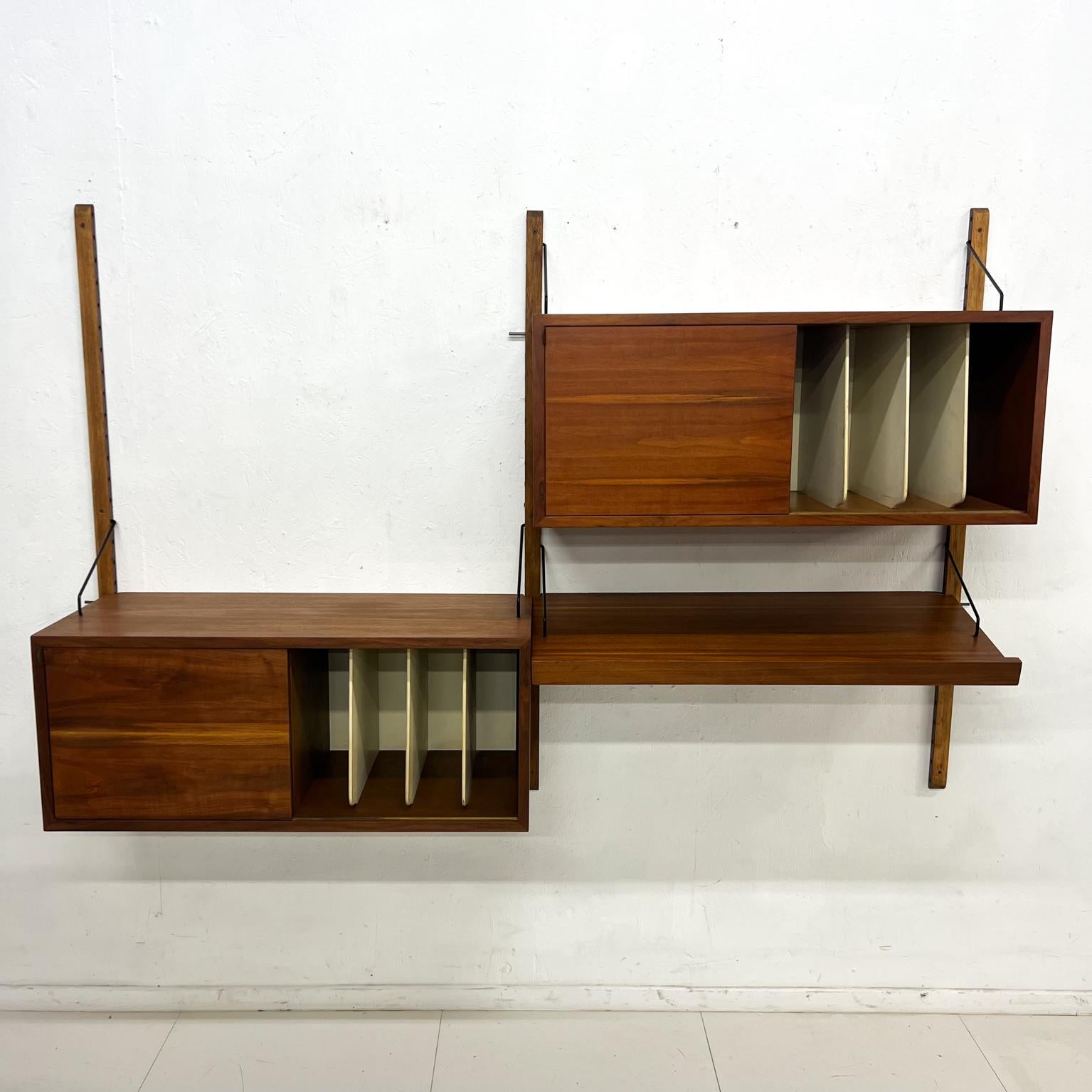 Vintage Scandinavian Modern wall unit system 2 bay in walnut wood.
Unmarked. Attribution Poul Cadovius for Royal System.
Two cabinets with sliding door. Space for records and open storage. 
One angle shelf. 
Measures: 73.5 wide x 49.5 tall (upright)