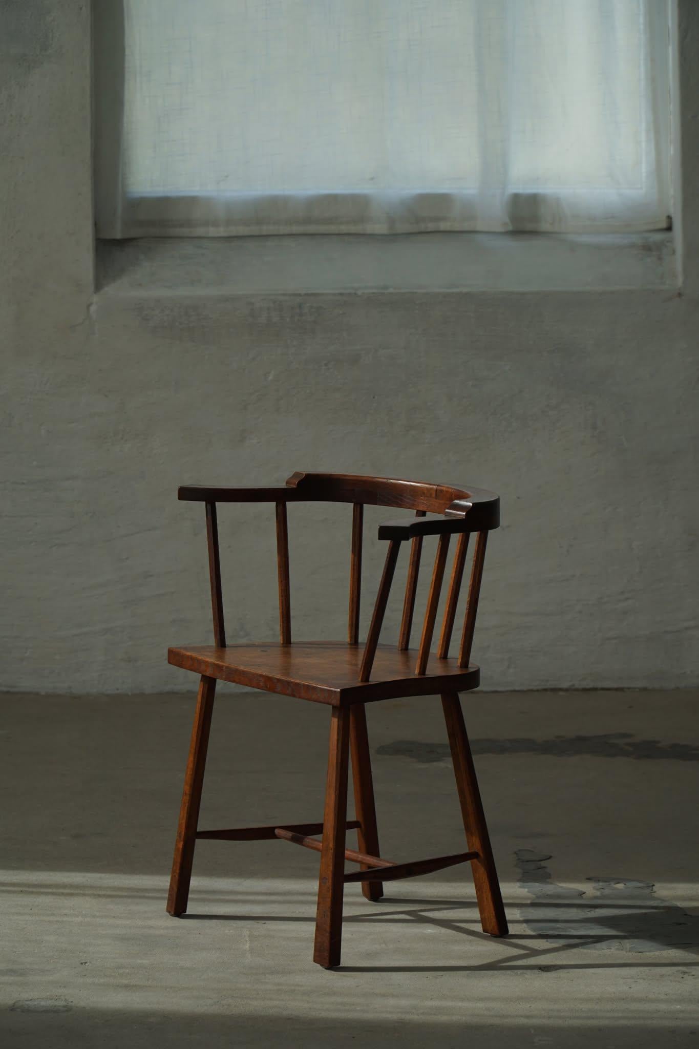 A set of eight elegant spindle-back chairs from the mid-20th century, crafted in solid oak by a Danish Cabinetmaker. These chairs showcase the clean, understated lines and functional elegance characteristic of Scandinavian design during this