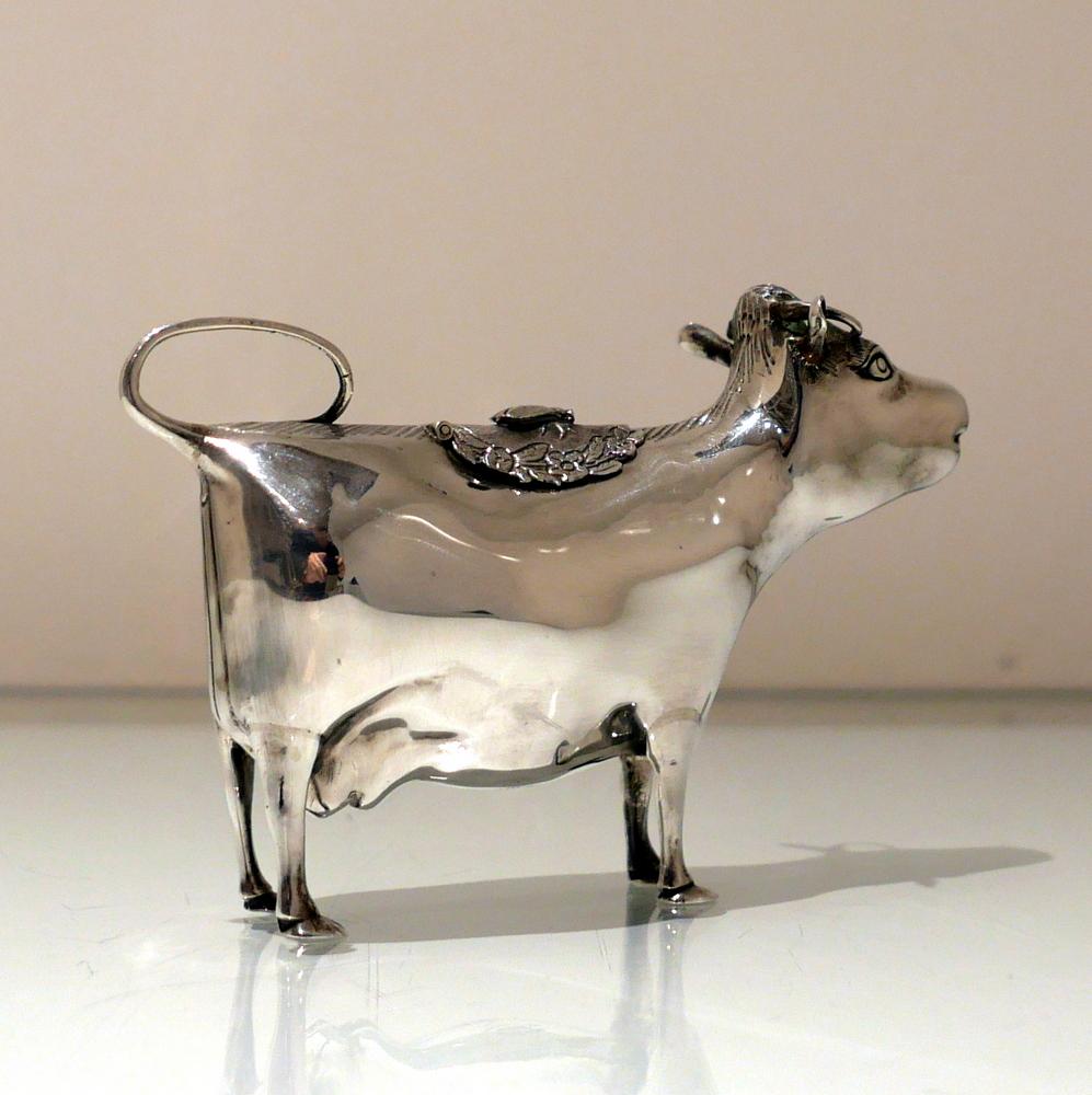 A beautiful sterling silver cow cream jug made by the highly renowned Carrington & Co. The model is elegantly formed with realistic features and a superbly ornate hinged flap.

 

Weight: 5.1 troy ounces/161 grams

Measures: Height 4