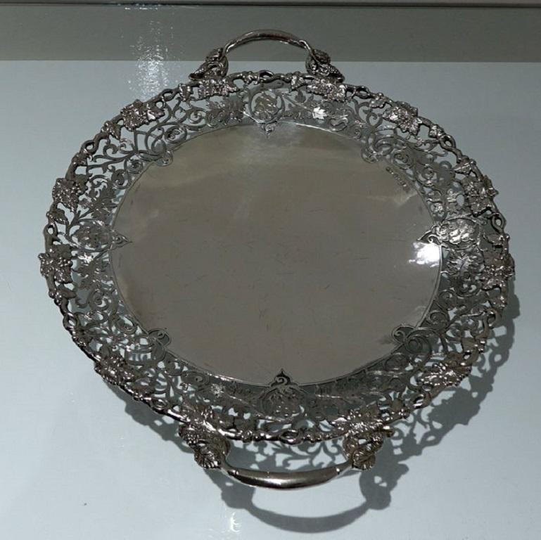 A very good quality and extremely collectable large circular dish/cake stand standing on a pedestal foot. The dish has a beautiful pierced floral engraved outer gallery and a elegant grape and vine applied border for decoration.