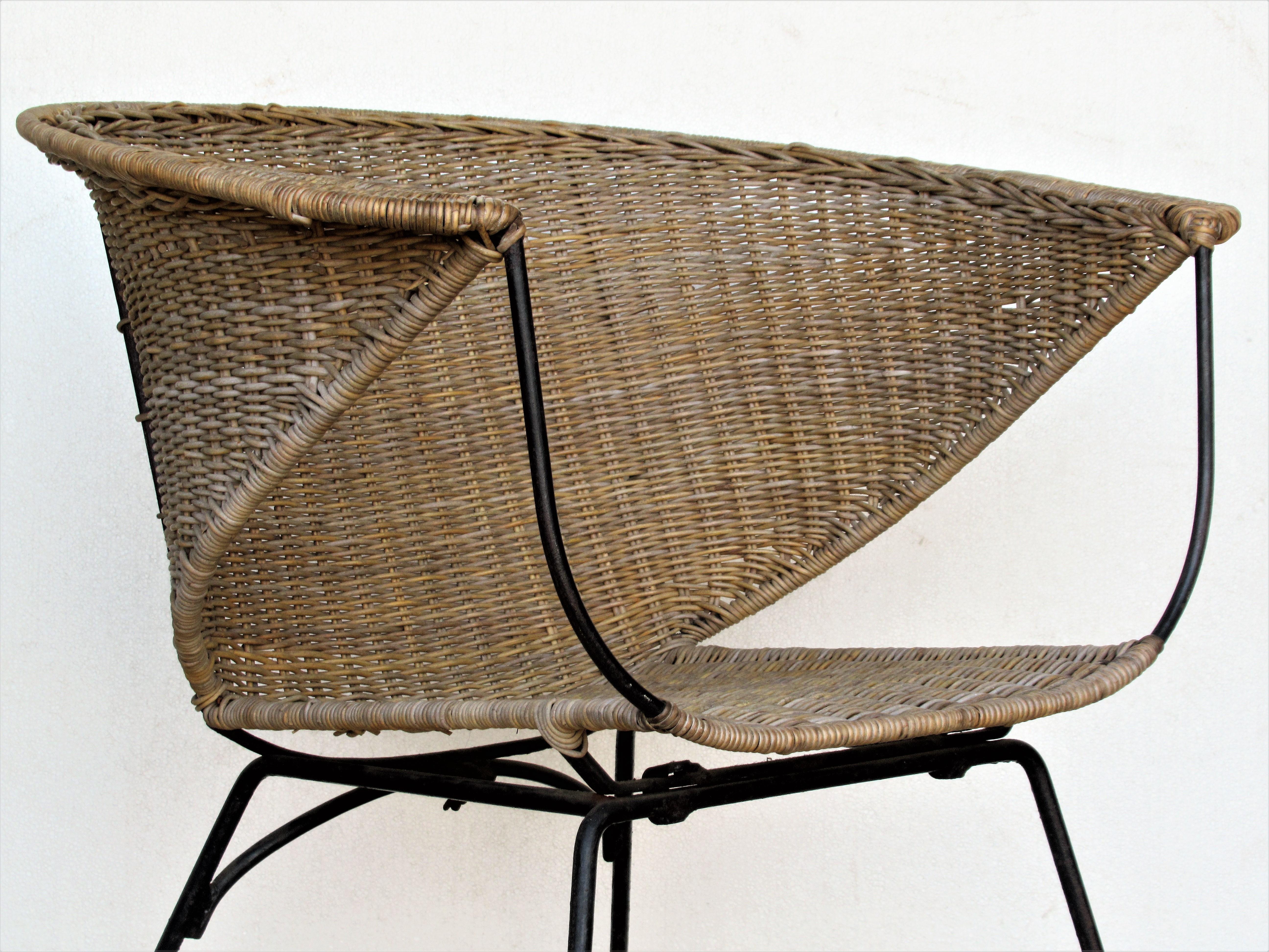 Mid 20th century modern iron and woven wicker rattan chair with a beautifully constructed sleek sculptural form. Look at all pictures and read condition report in comment