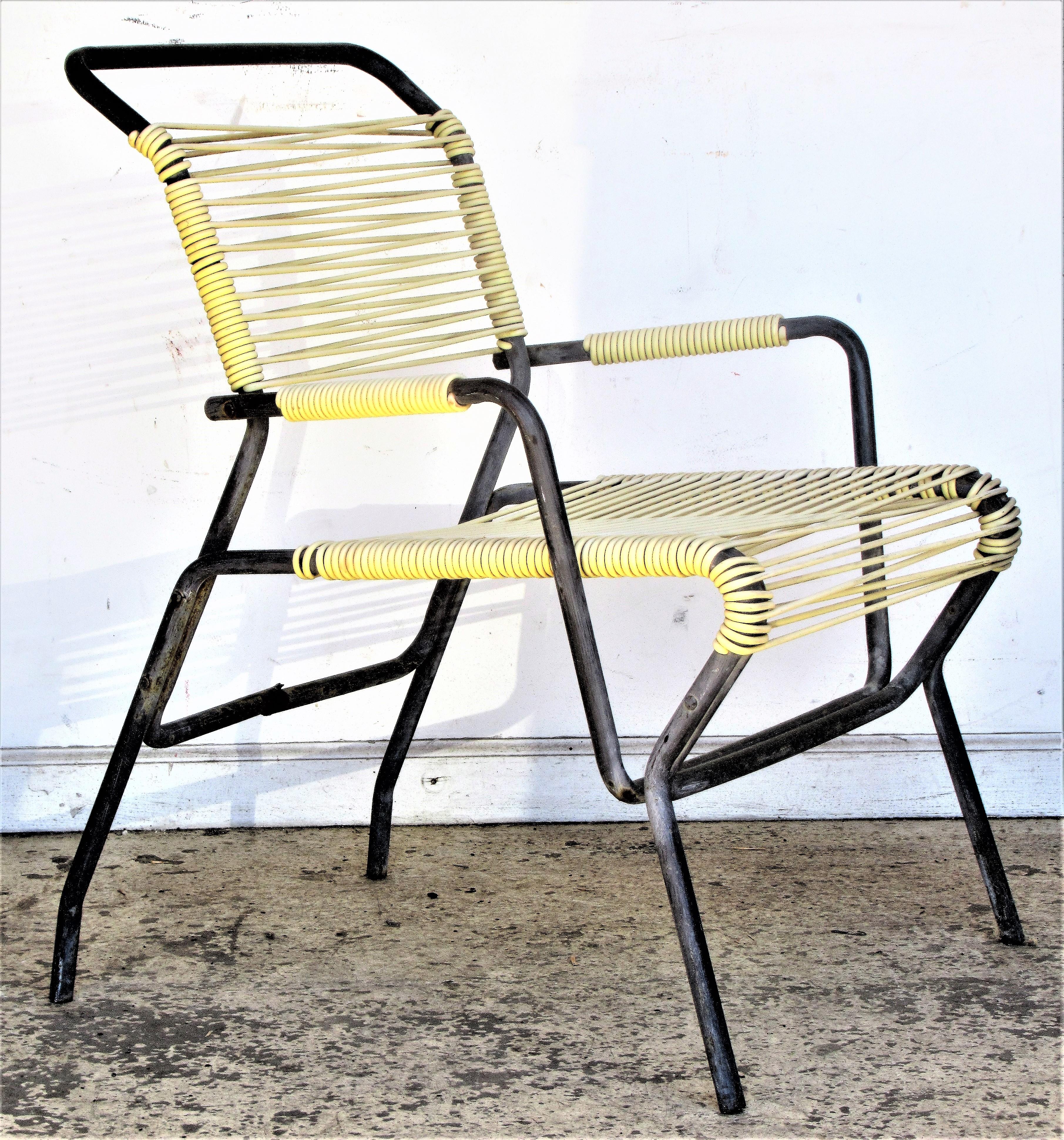 Modernist tubular iron and rubber nylon corded patio chairs by Surf Line with an exceptionally great looking sculptural form, Circa 1950's. In the style of Walter Lamb for Brown Jordan. Armchair in original blackened surface measures 30