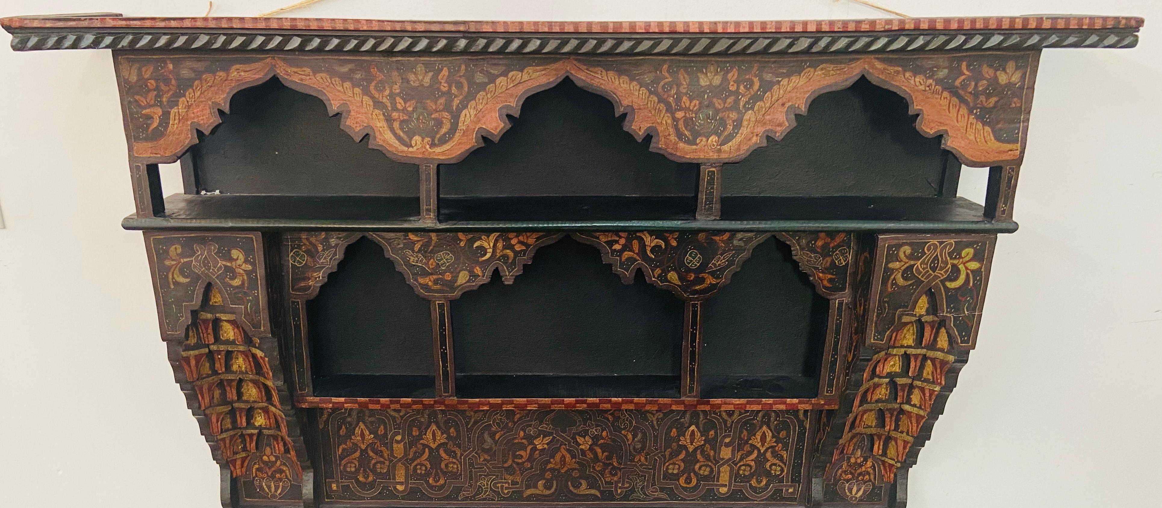 A mid-20th century Moroccan wall shelf or spice rack. The Moroccan shelf is beautifully handprinted and features centuries old Moorish design of geometrical patterns and arch. An exotic addition to your living room, dining room or kitchen walls.
