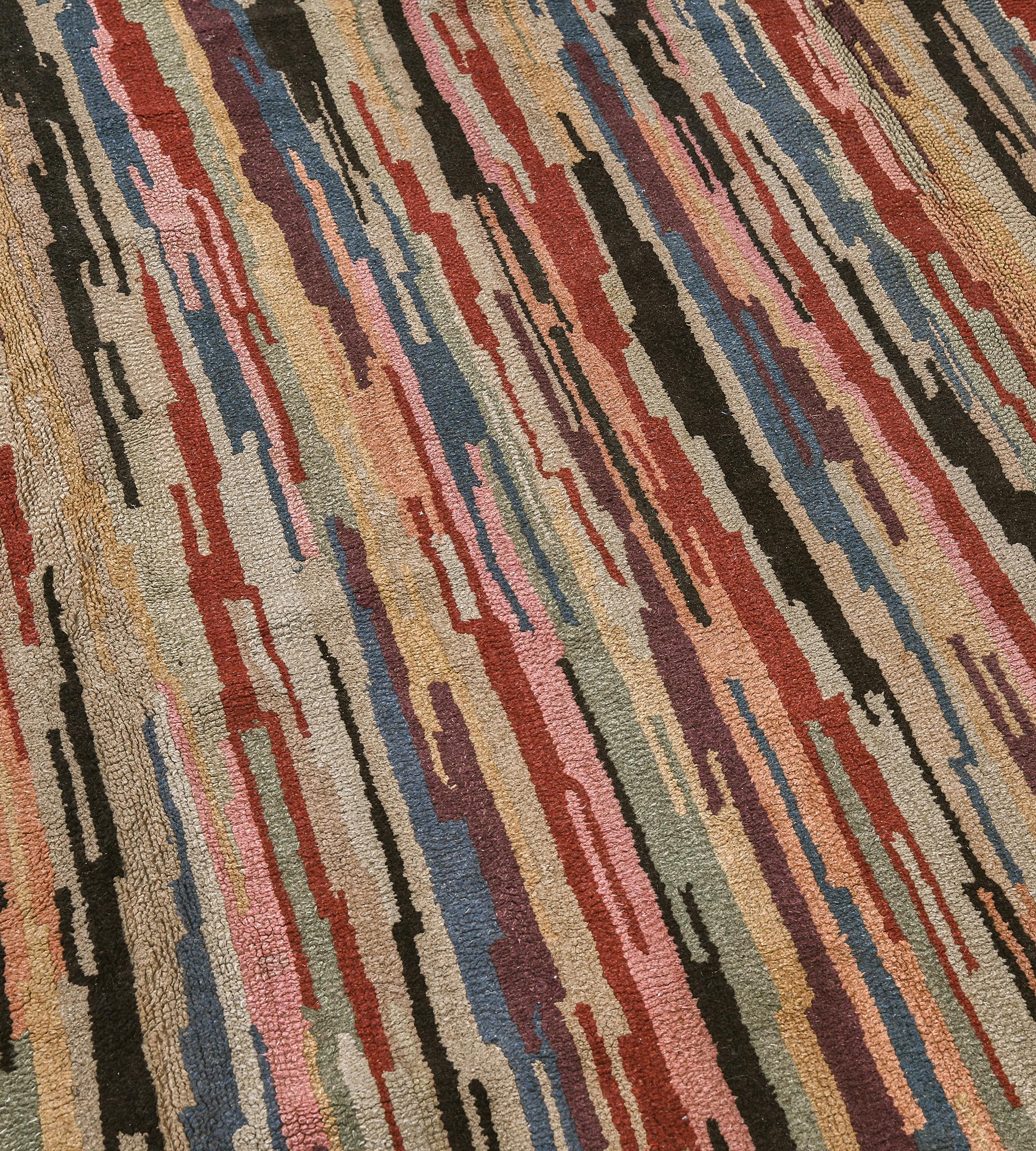 This vintage handwoven North American Hooked rug has an overall field of gently waving vertical polychrome strokes of green, blue, purple, pink, red and black, on a beige background.

North American hook rugs are a traditional folk art form that