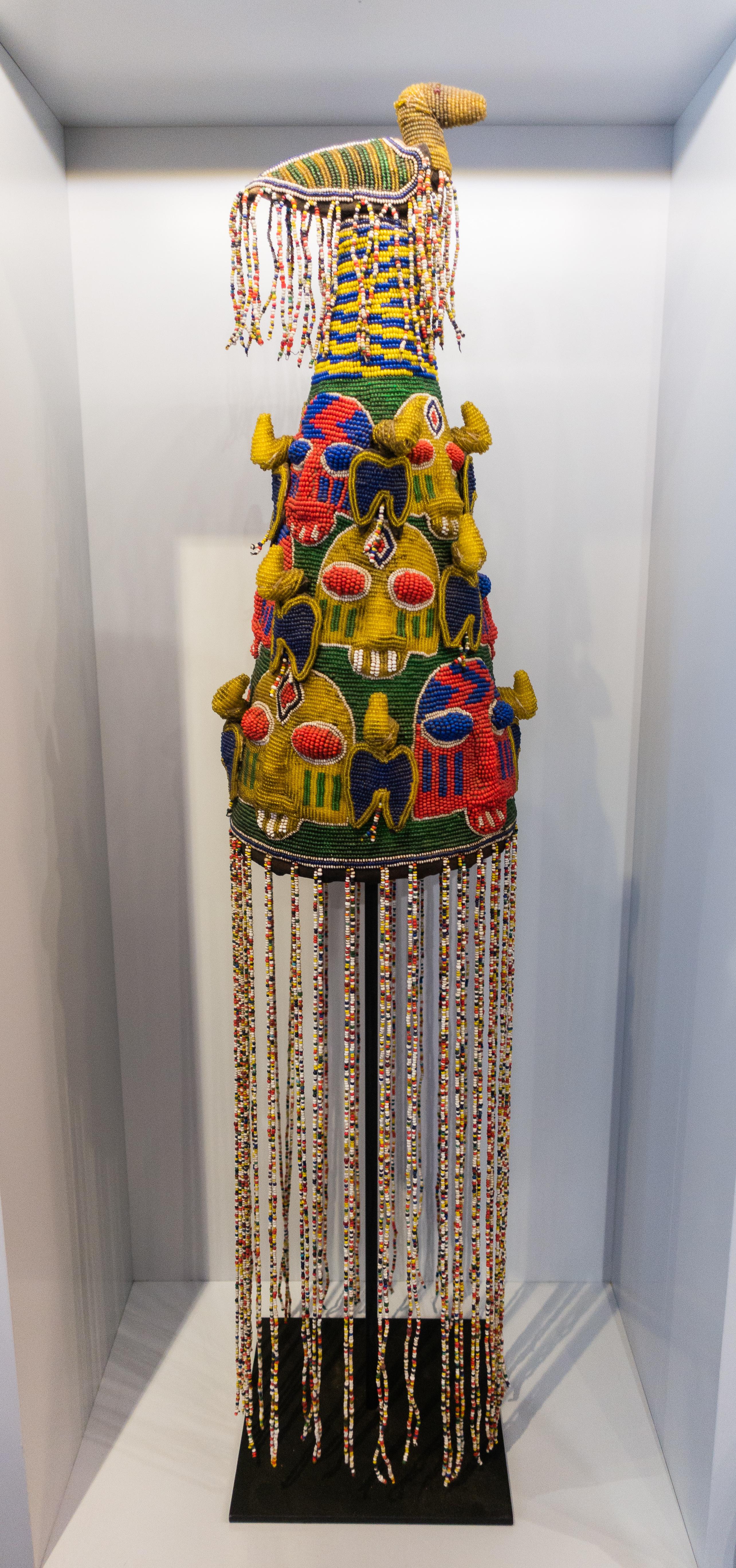 Multi-color beaded ceremonial headdress from Nigeria mounted on a custom metal stand, mid-20th century.