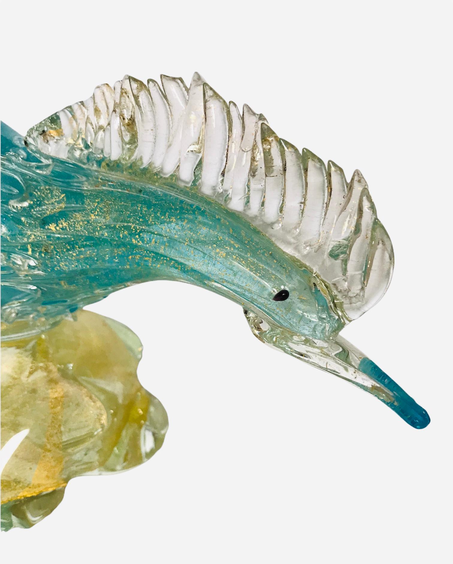 This 50’s Italian Murano glass pheasant bird figurine is a colorful representation of Mid-Century modern decor. Tall in stature, the beautiful hand-blown glass sculpture presents gold flecks amongst the stunning aquamarine shade of blue.