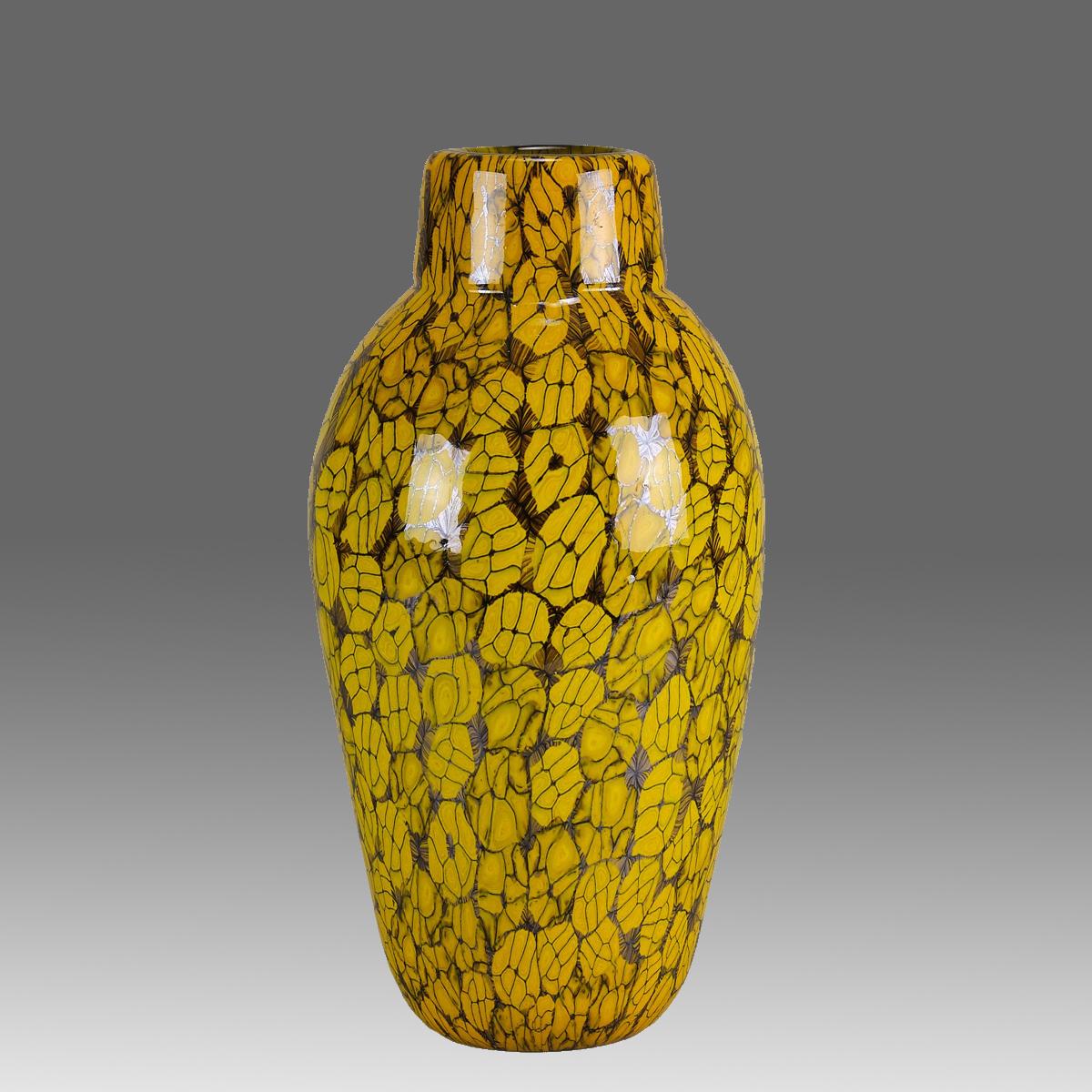 A vibrant modernist hand blown glass vase cased with an eyecatching Murrine yellow floral medallion design with brown borders. Signed Ferro Vittorio and with original Murano label

ADDITIONAL INFORMATION
Height:                                     