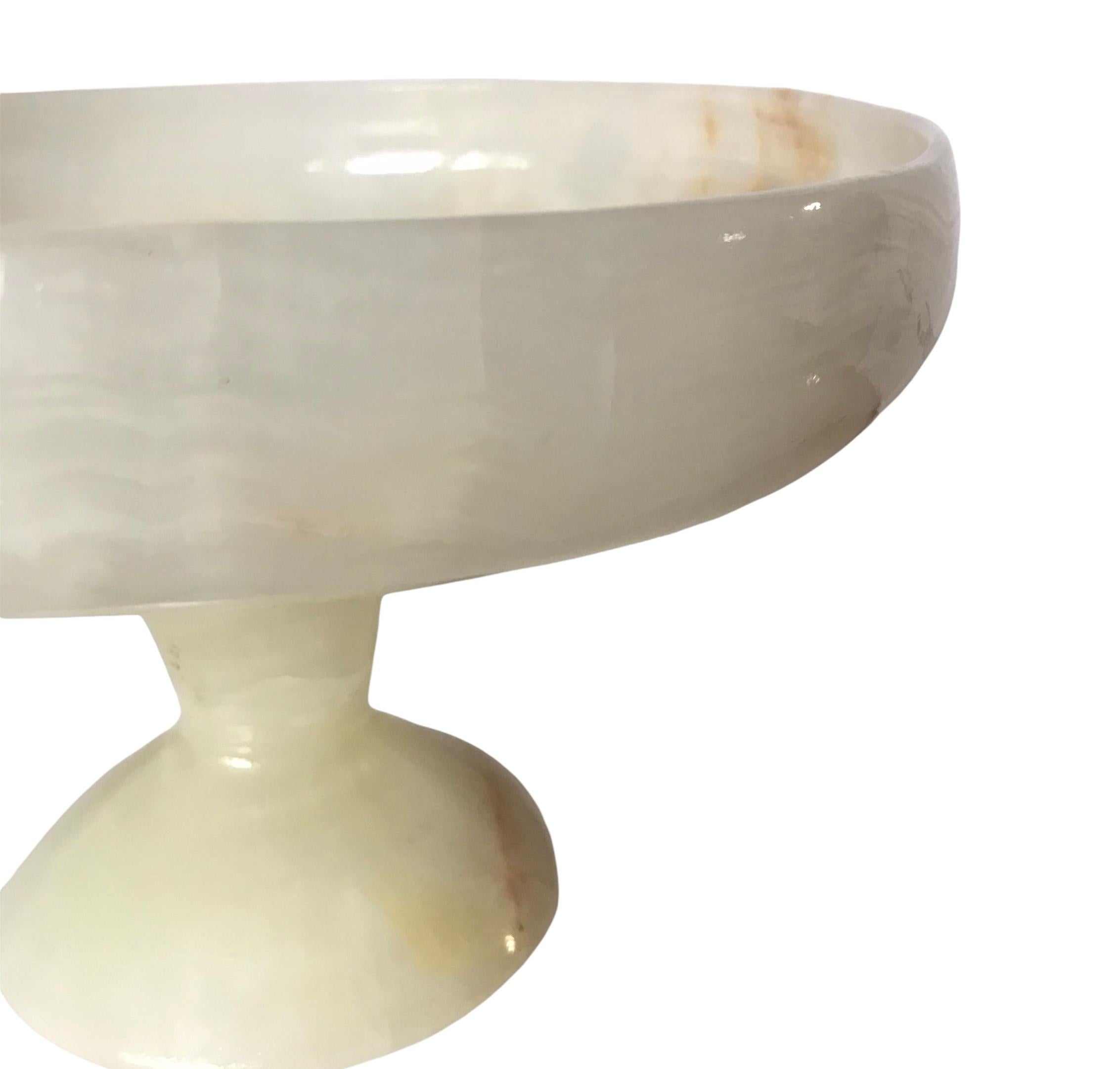 Natural hand carved onyx bowl perched on a pedestal. Lovely mix of cream white with highlights of copper brown.