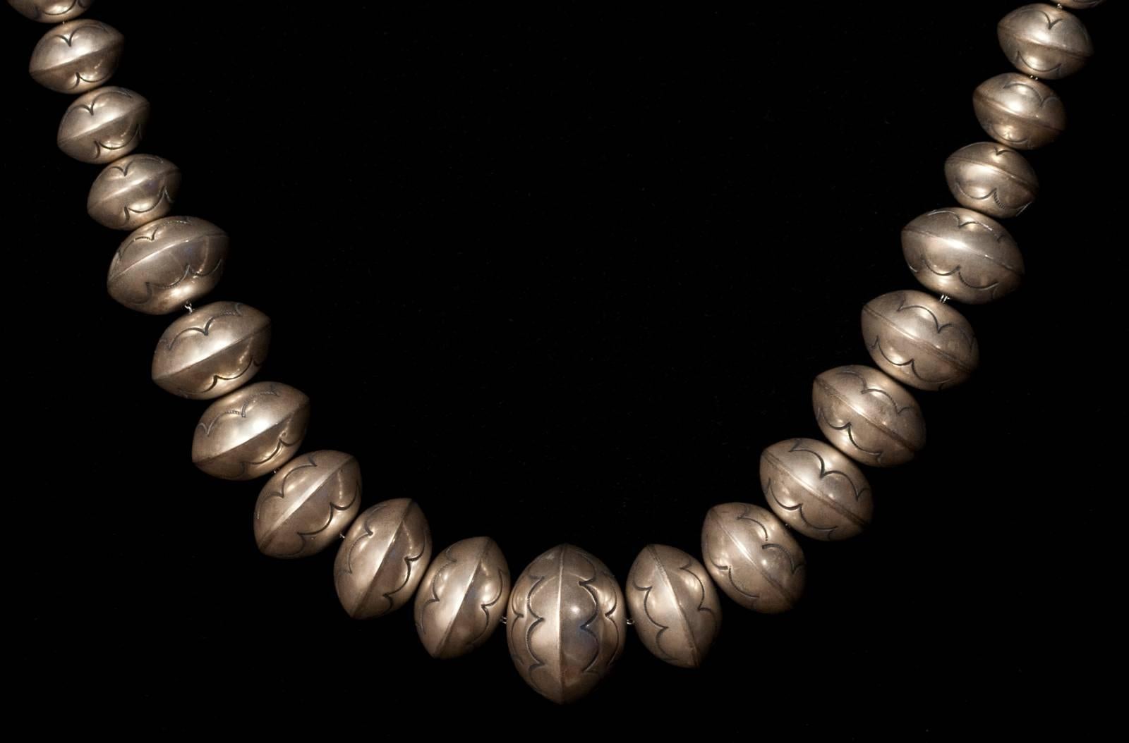 Offered by Zena Kruzick
Mid-20th century Navajo silver pearl necklace.

This long, elegant graduated pearl necklace is strung on a silver chain. There is a small round disk at the clasp with the initials L Y chased in script, possibly Louise or