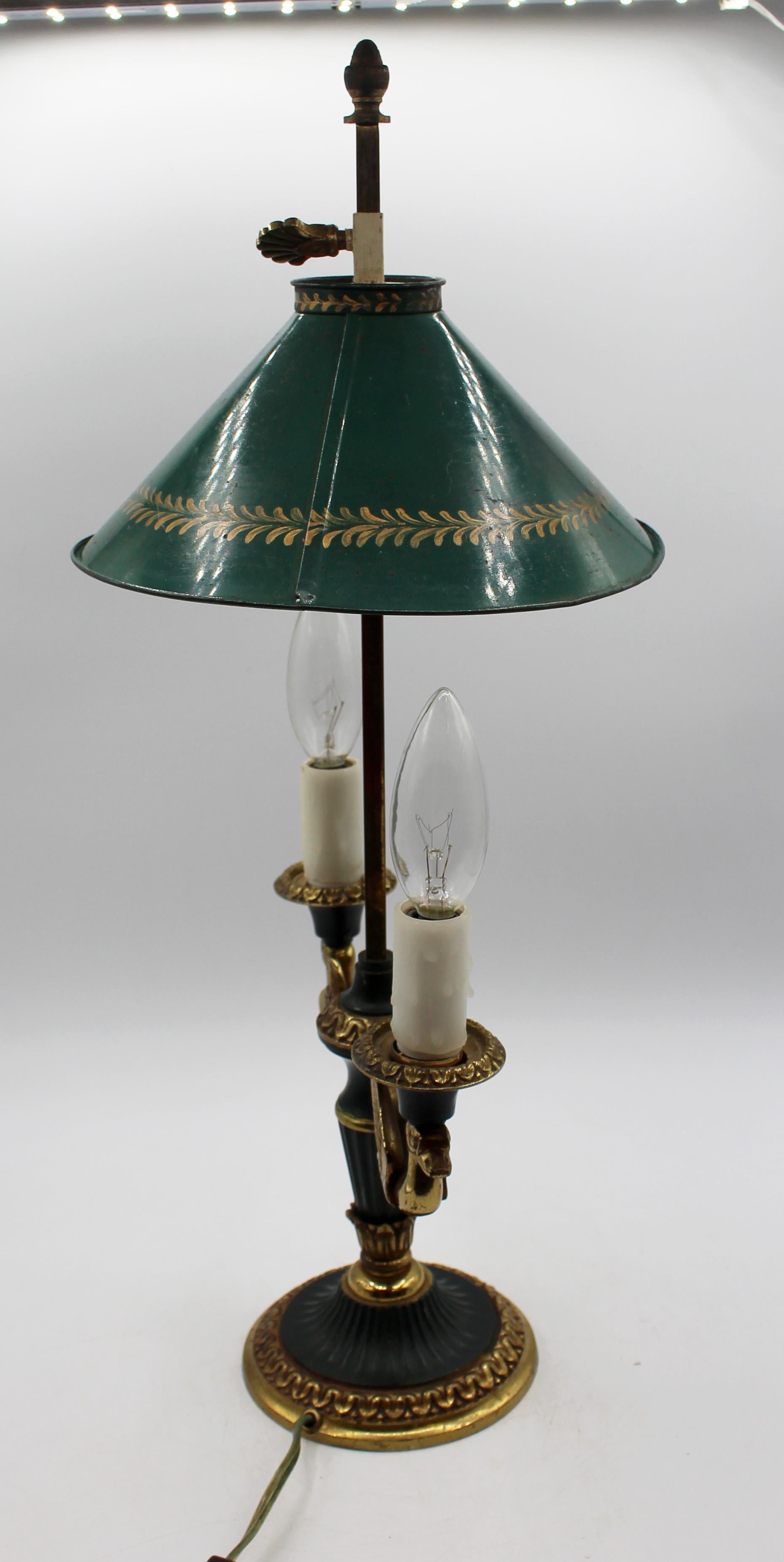 Mid-20th century bronze swan motif bouillotte lamp. Neoclassical style. Double light. Green paint & gilt bronze. Green tole shade with gilt repetitive motif borders. 8.25