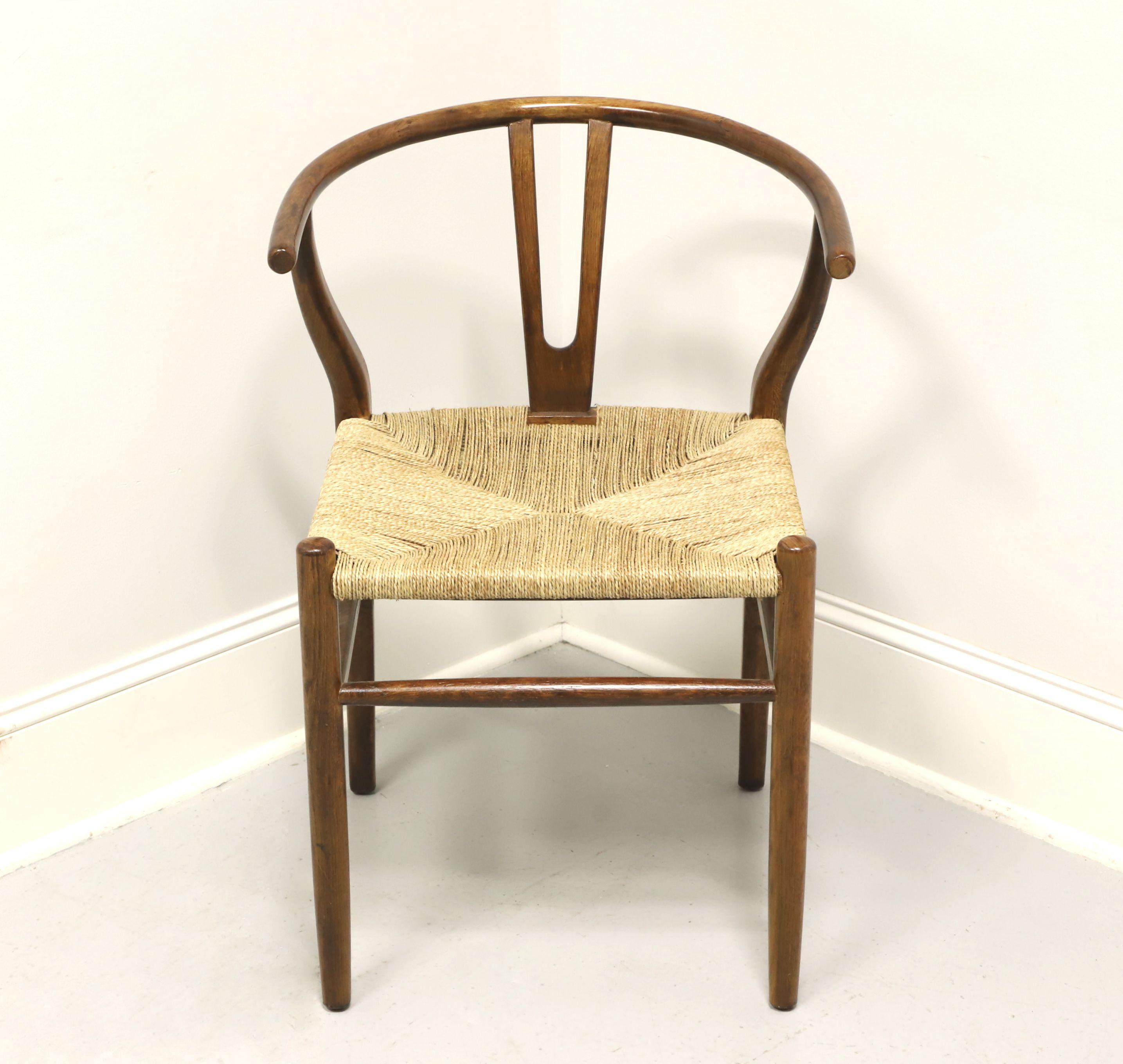 A Chinese Ming style armchair, unbranded. Solid oak with a chestnut color finish, slender curved arms that form the crest rail, 