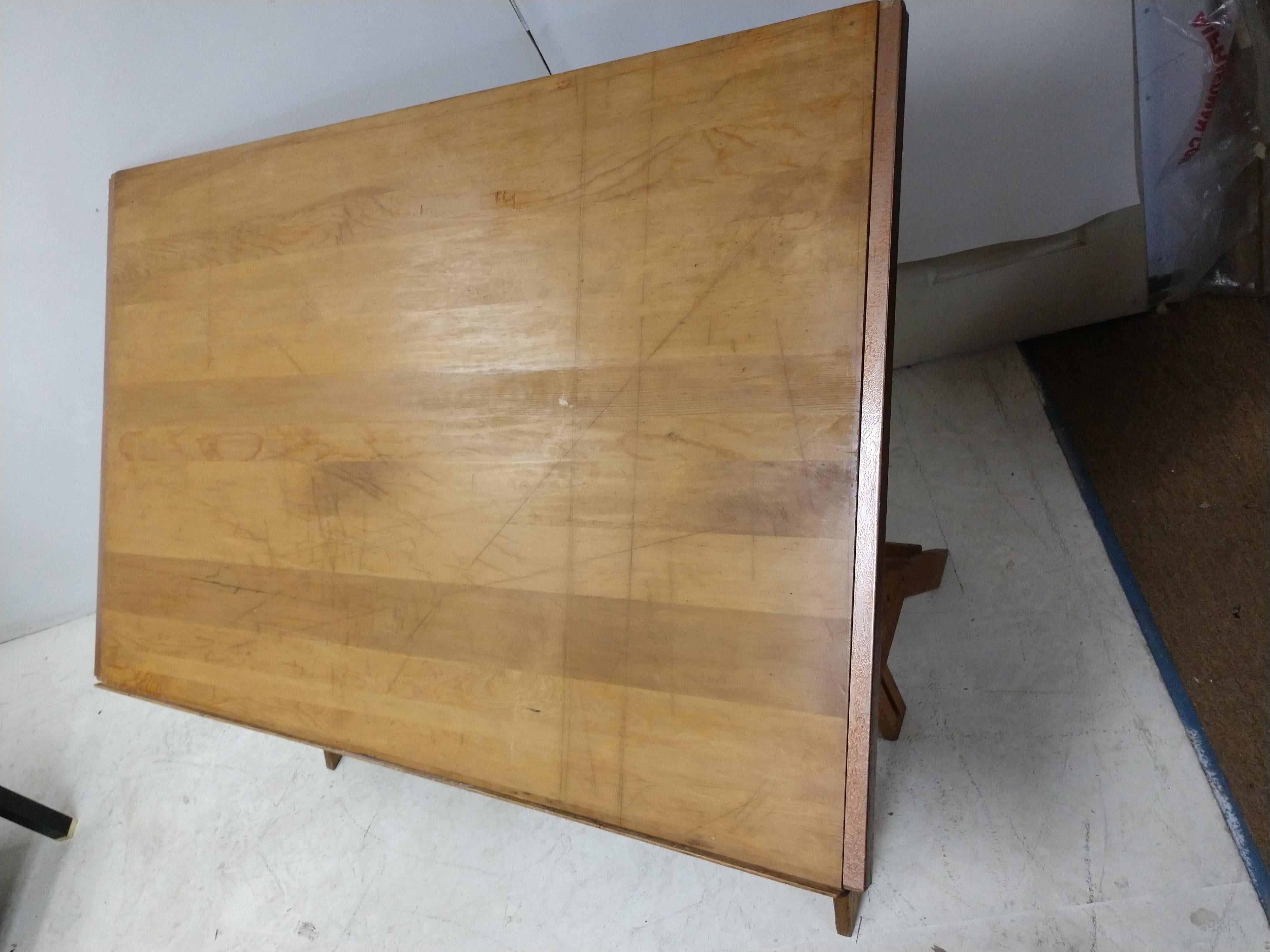 Large (top is 38.5 x 60) maple top on oak base, (base is 28x 50). Raises from 32 to a height of 42 flat. Tilts to any angle. In excellent vintage condition with minor wear to the top. Top unbolts for transporting. Works perfectly.