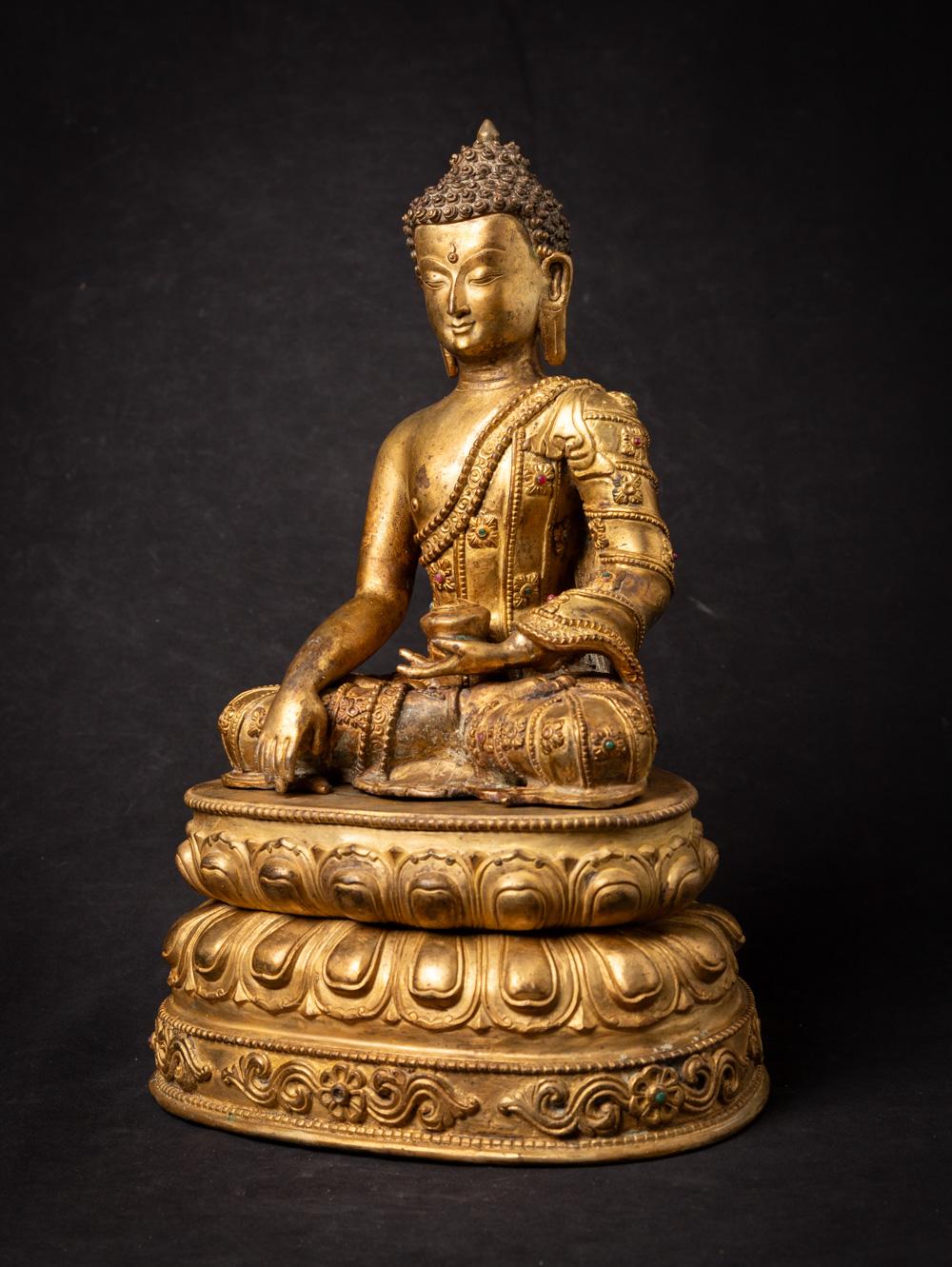 The old bronze Nepali Buddha statue you've described is a captivating and intricately detailed work of art. Crafted from bronze and originating from Nepal, this statue showcases both artistic skill and spiritual significance.

Standing at 38.5 cm in