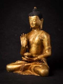 Mid-20th century old bronze Nepali Buddha statue in Abhaya Mudra