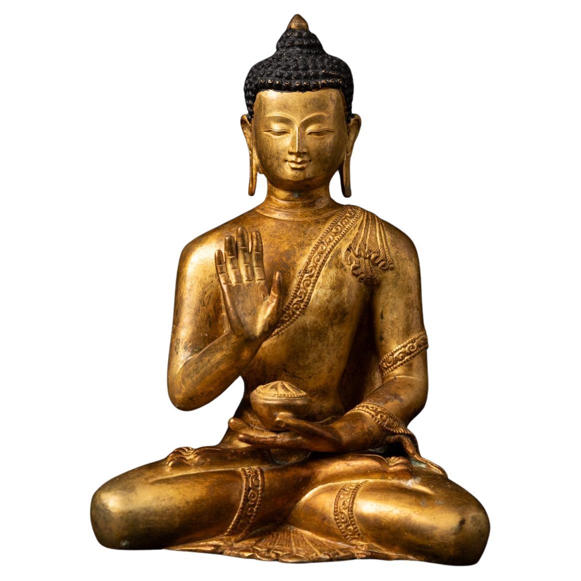 Mid-20th century old bronze Nepali Buddha statue in Abhaya Mudra