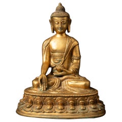 Mid-20th century old bronze Nepali Buddha statue in Varada Mudra