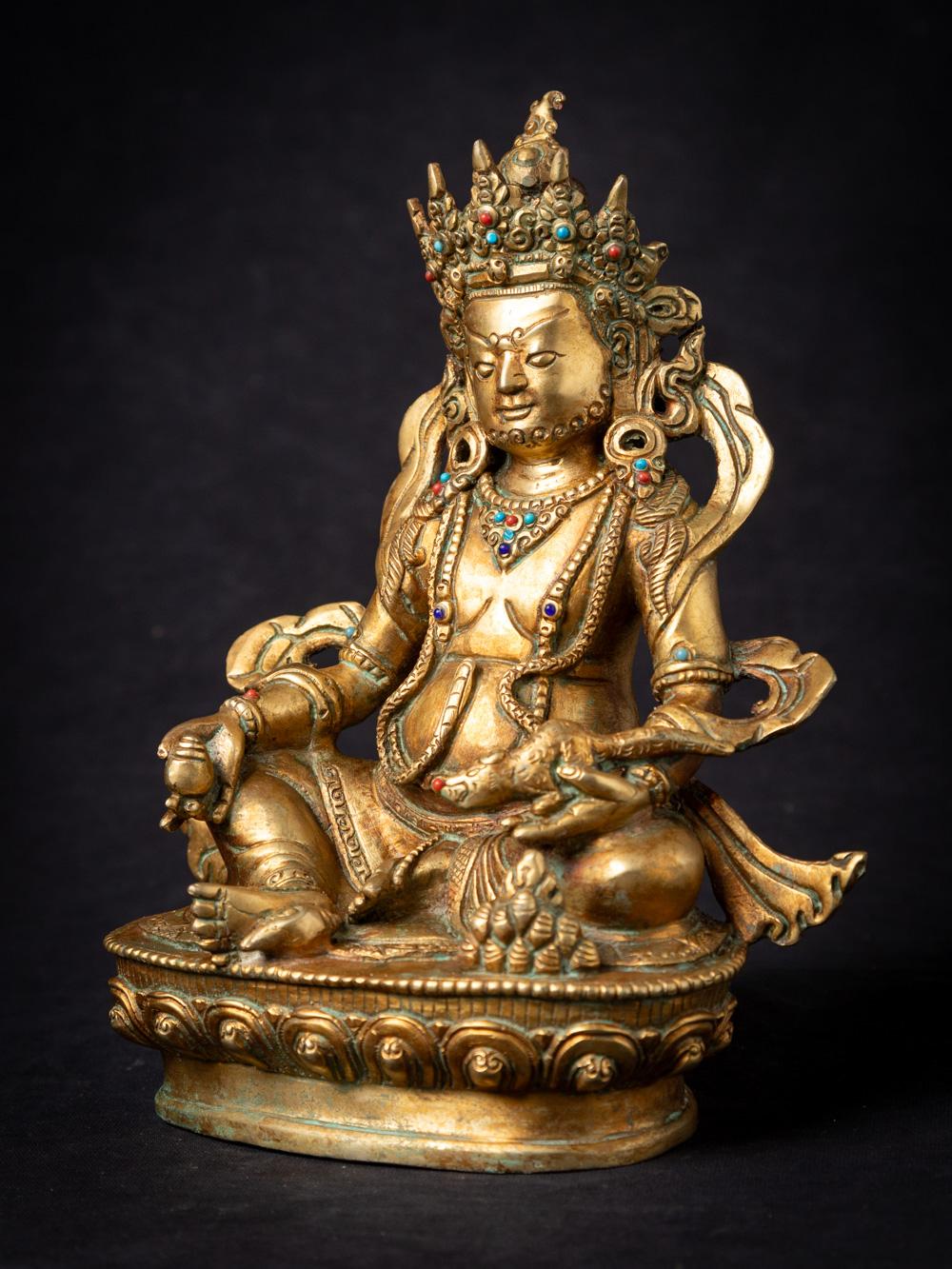 This old bronze Nepali Kuber statue is a remarkable piece of art that reflects the rich cultural and religious traditions of Nepal. Crafted from bronze and fire-gilded with 24-karat gold, this statue stands at a height of 22.1 cm, with dimensions of