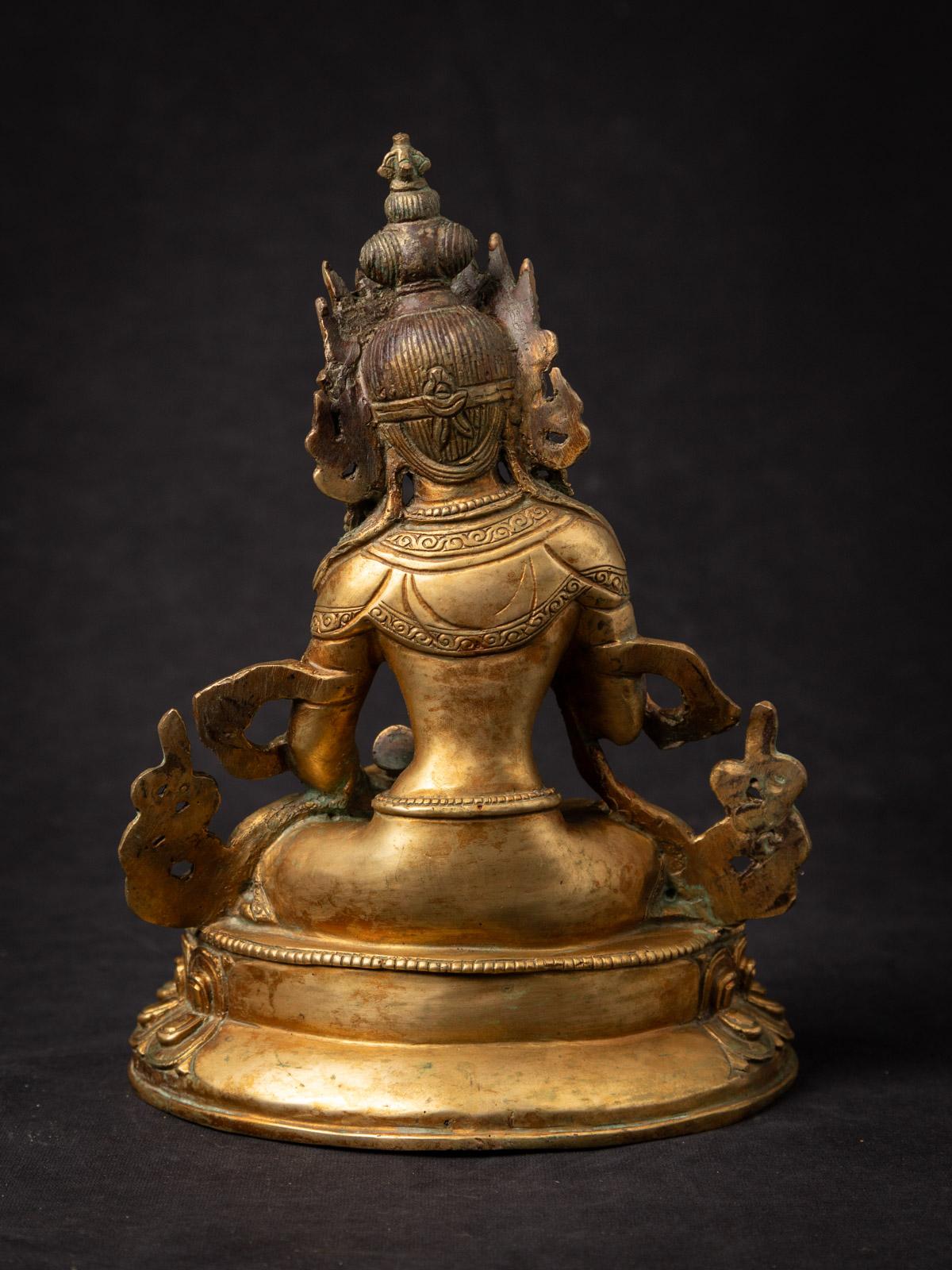 This bronze sculpture, originating from Nepal during the middle of the 20th century, is a stunning work of artistry. It stands at a height of 23,9 m and boasts dimensions of 17,2 m in width and 12,6 cm in depth. Crafted from bronze and meticulously