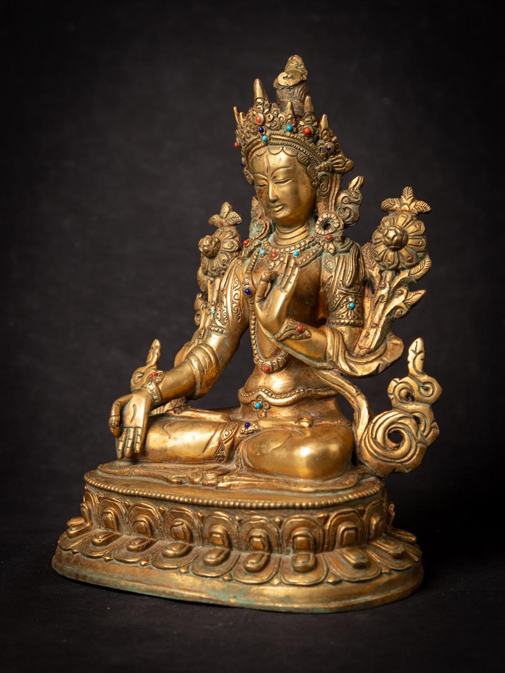 This bronze sculpture, originating from Nepal during the mid-20th century, is a true work of art. It stands at a height of 22.3 cm and boasts dimensions of 17 cm in width and 12.5 cm in depth. Crafted from bronze and fire-gilded with 24-karat gold,