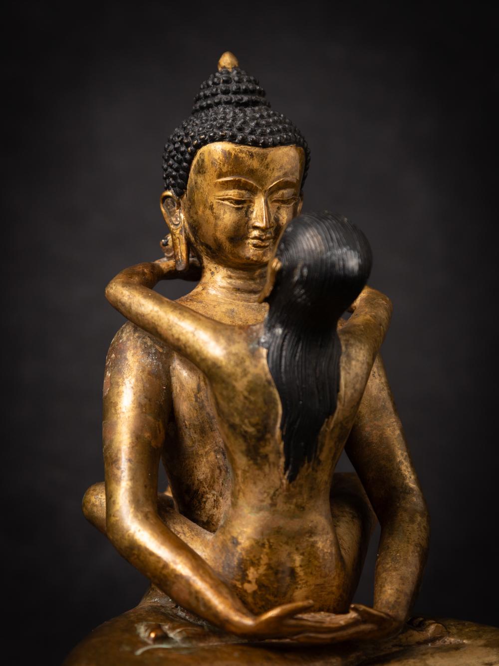 The old bronze Samantabhadra statue from Nepal is a captivating and spiritually meaningful artifact. Crafted from bronze and adorned with fire gilding in 24-karat gold, this statue stands at 21.6 cm in height and measures 16.7 cm in width and 15.3