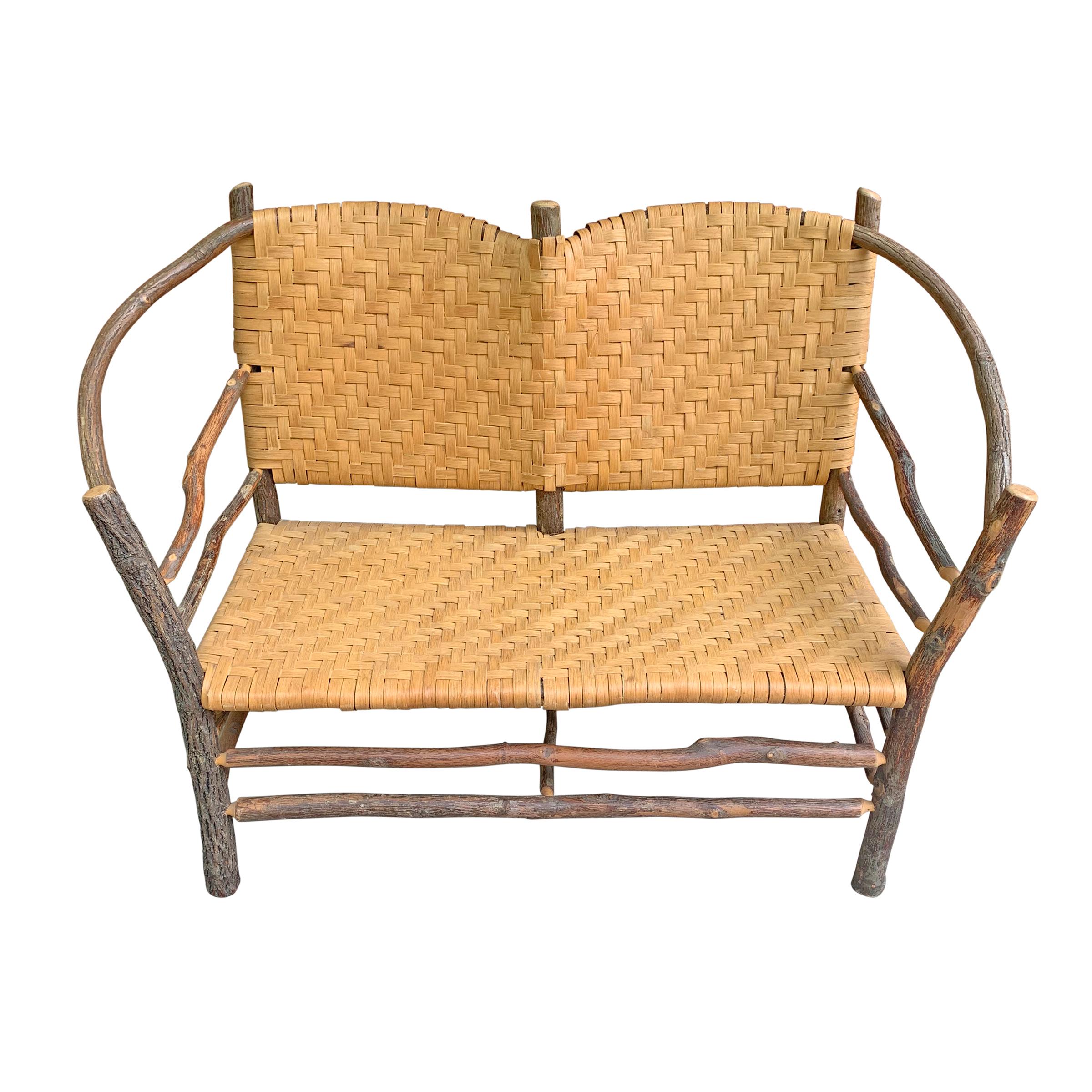 A wonderfully charming mid-20th century American Old Hickory barrel-back settee with a bent hickory frame and a woven splint seat and back. The perfect settee for your front porch or sunroom of your country cottage.