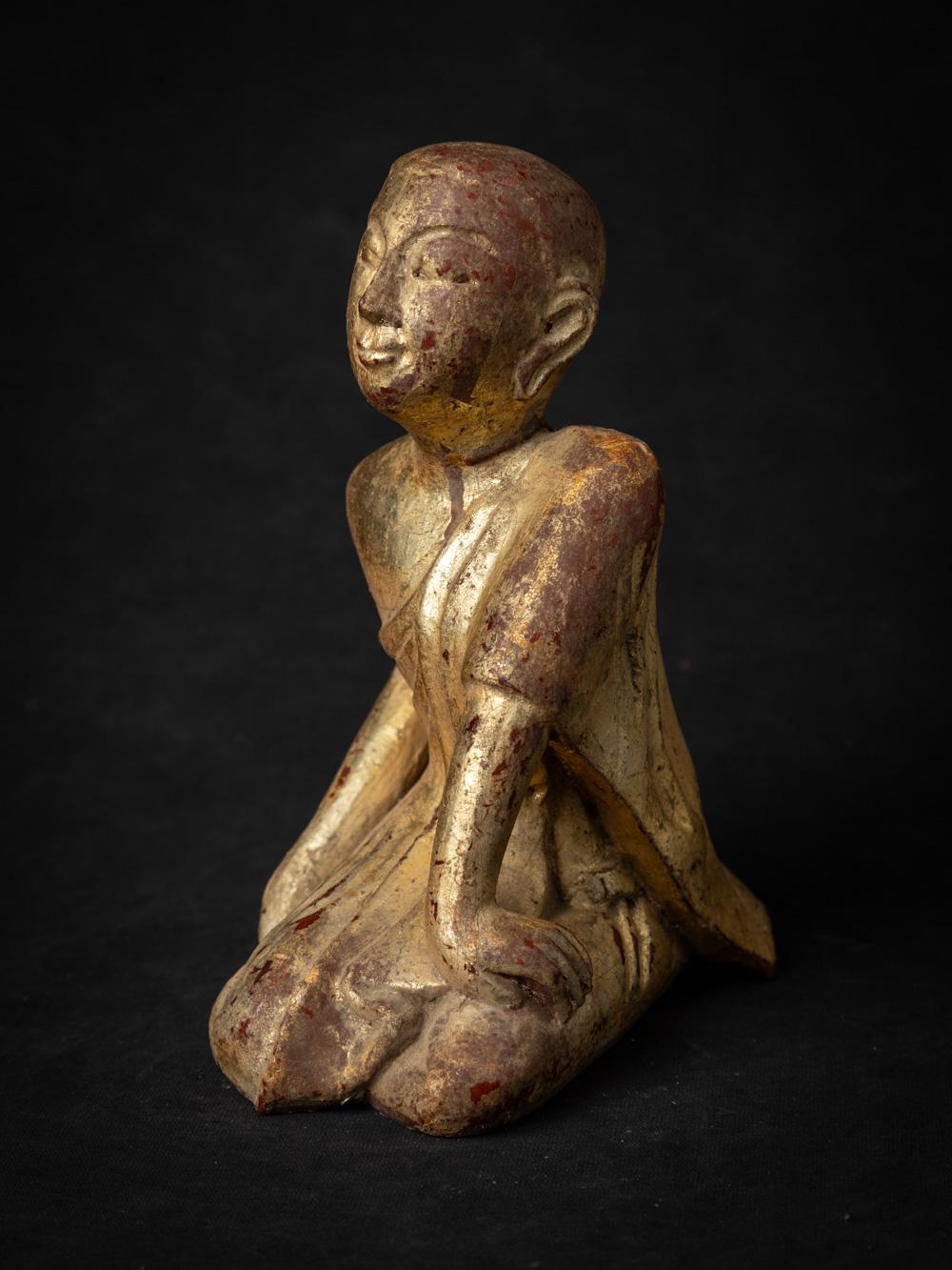 This old wooden Burmese Monk statue is a testament to the artistic traditions and spiritual heritage of Burma (now Myanmar). Crafted from wood, this statue stands at a height of 18.5 cm with dimensions of 9.8 cm in width and 13.7 cm in depth. Dating