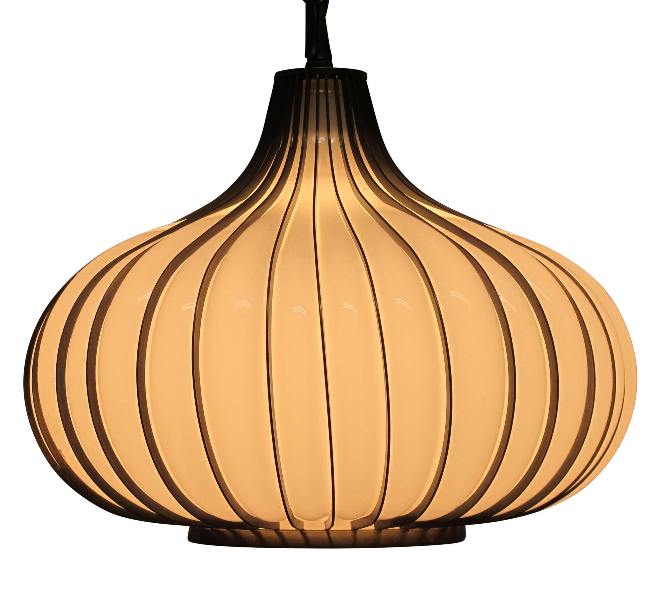 Onion or garlic shaped pendant light fixture, white blown glass in brass finished metal cage. Newly re-wired, holds a single standard size light bulb, American mid-20th century.
