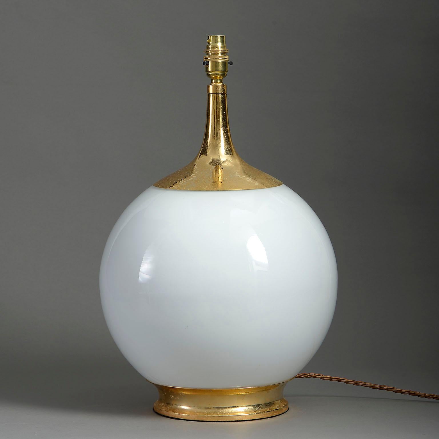 A mid-twentieth century Futurist lamp base, the opaline glass body with gilt metal cap and base.

Dimensions include period parts only and do not include the bayonet bulb holder.

Wired to UK specifications. This lamp can be rewired to all