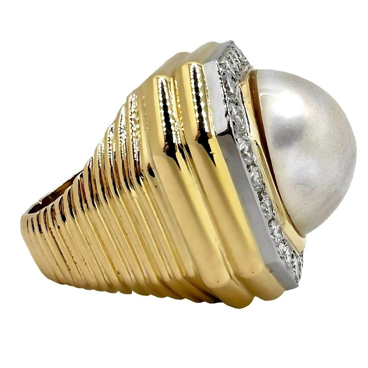 This opulent, massive ring is crafted to the finest jewelry making standards. Measures 1 inch in diameter with a center 18mm Cream Rose Mabe pearl that is encircled by a line of twenty four brilliant cut diamonds set in a platinum plate. Total