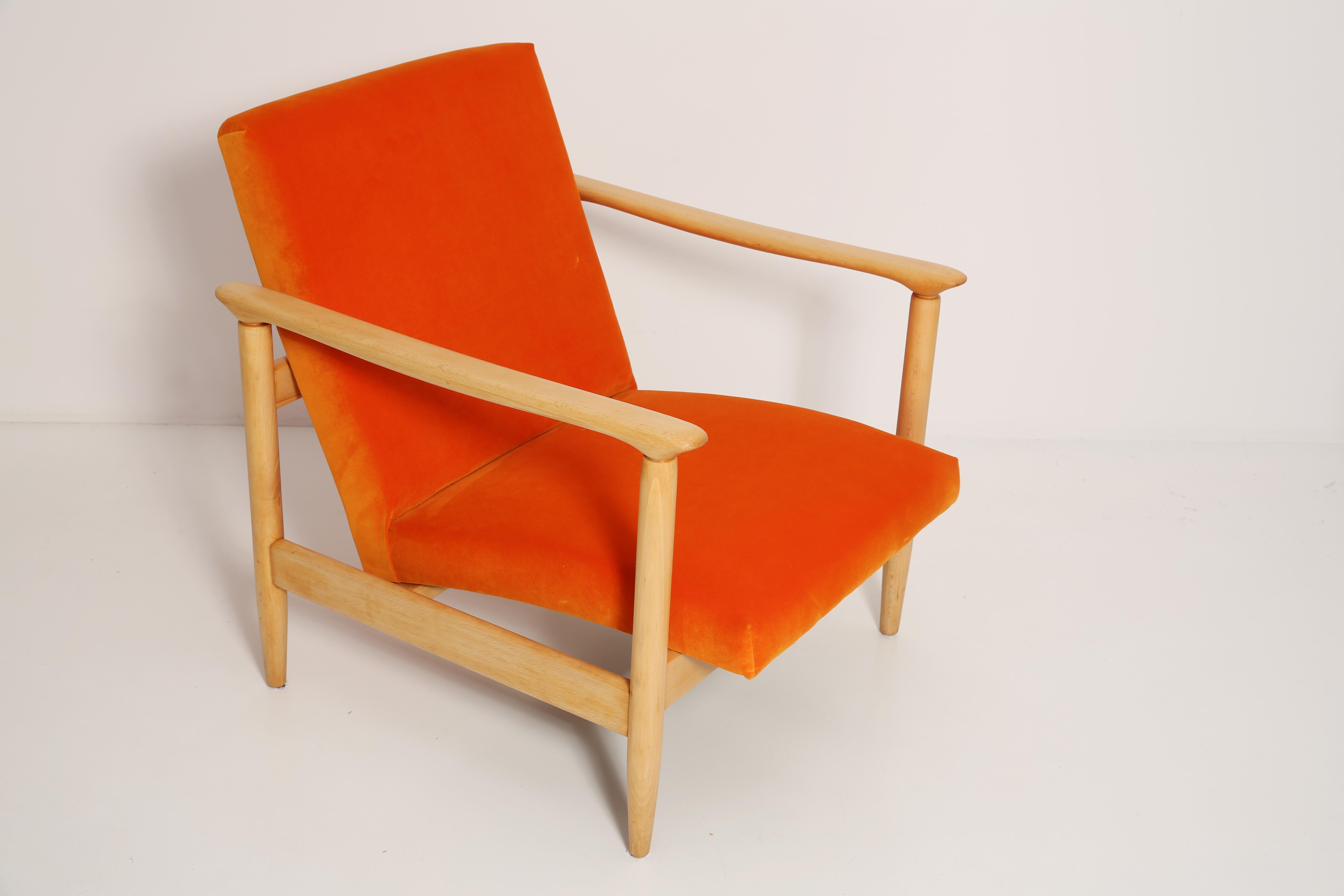 Beautiful bright orange velvet Armchair GFM-142, designed by Edmund Homa, a polish architect, designer of Industrial Design and interior architecture, professor at the Academy of Fine Arts in Gdansk. 

The armchair was made in the 1960s in the