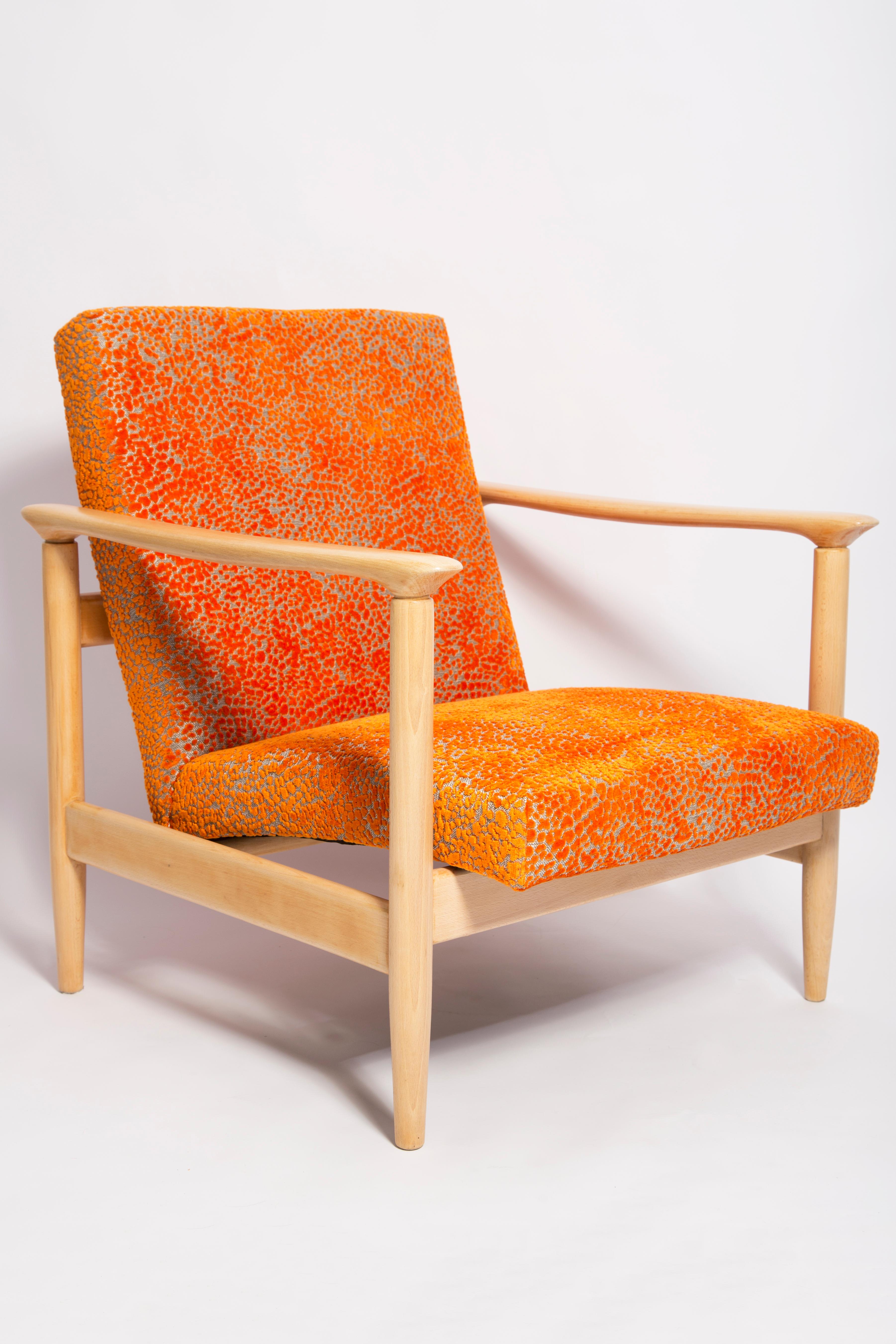 Beautiful bright orange velvet Armchair GFM-142, designed by Edmund Homa, a polish architect, designer of Industrial Design and interior architecture, professor at the Academy of Fine Arts in Gdansk. 

The armchair was made in the 1960s in the