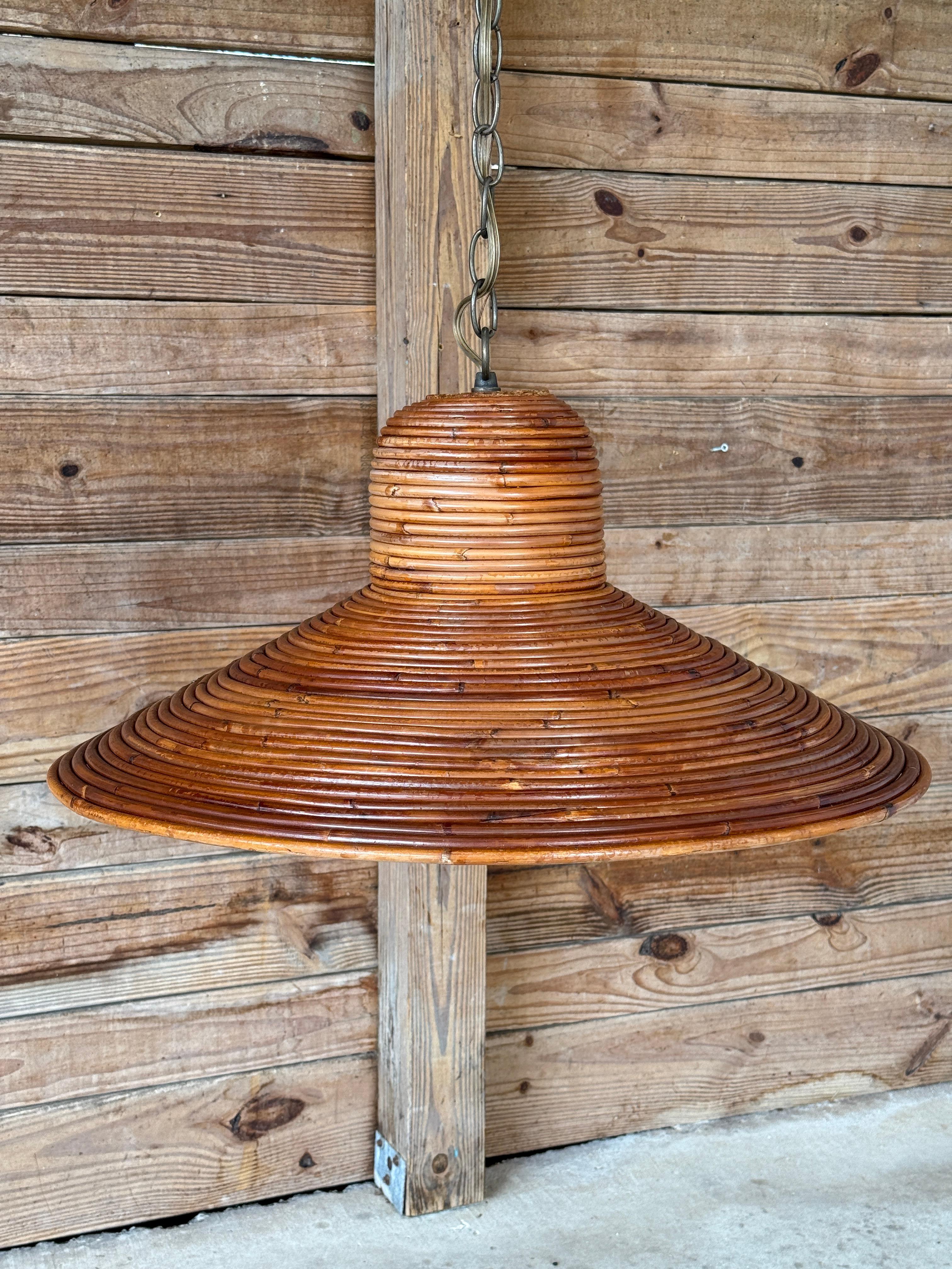 A striking mid-century pencil reed rattan pendant chandelier, exuding organic modern charm with its woven texture and sculptural form.
Featuring a wide, tapered silhouette, this fixture casts a warm, diffused glow, perfect for coastal, bohemian, or