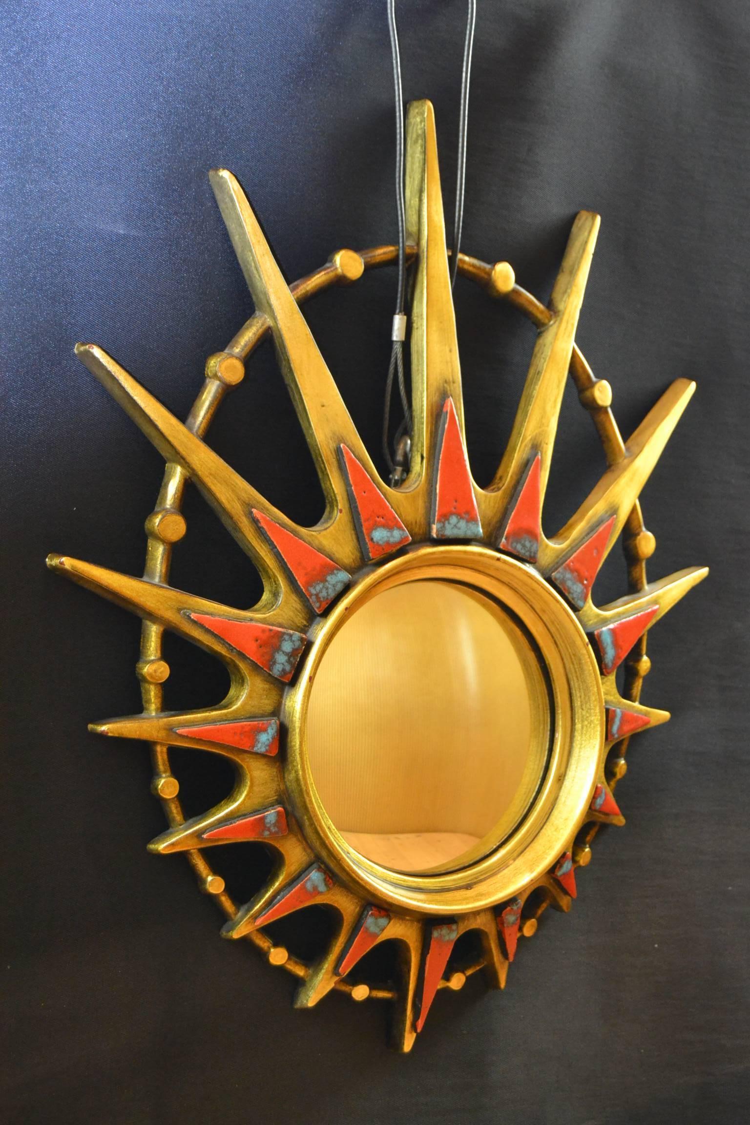 Hollywood Regency Mid-20th Century Oval Gilded Sunburst Mirror with Blue and Red Ceramic Details