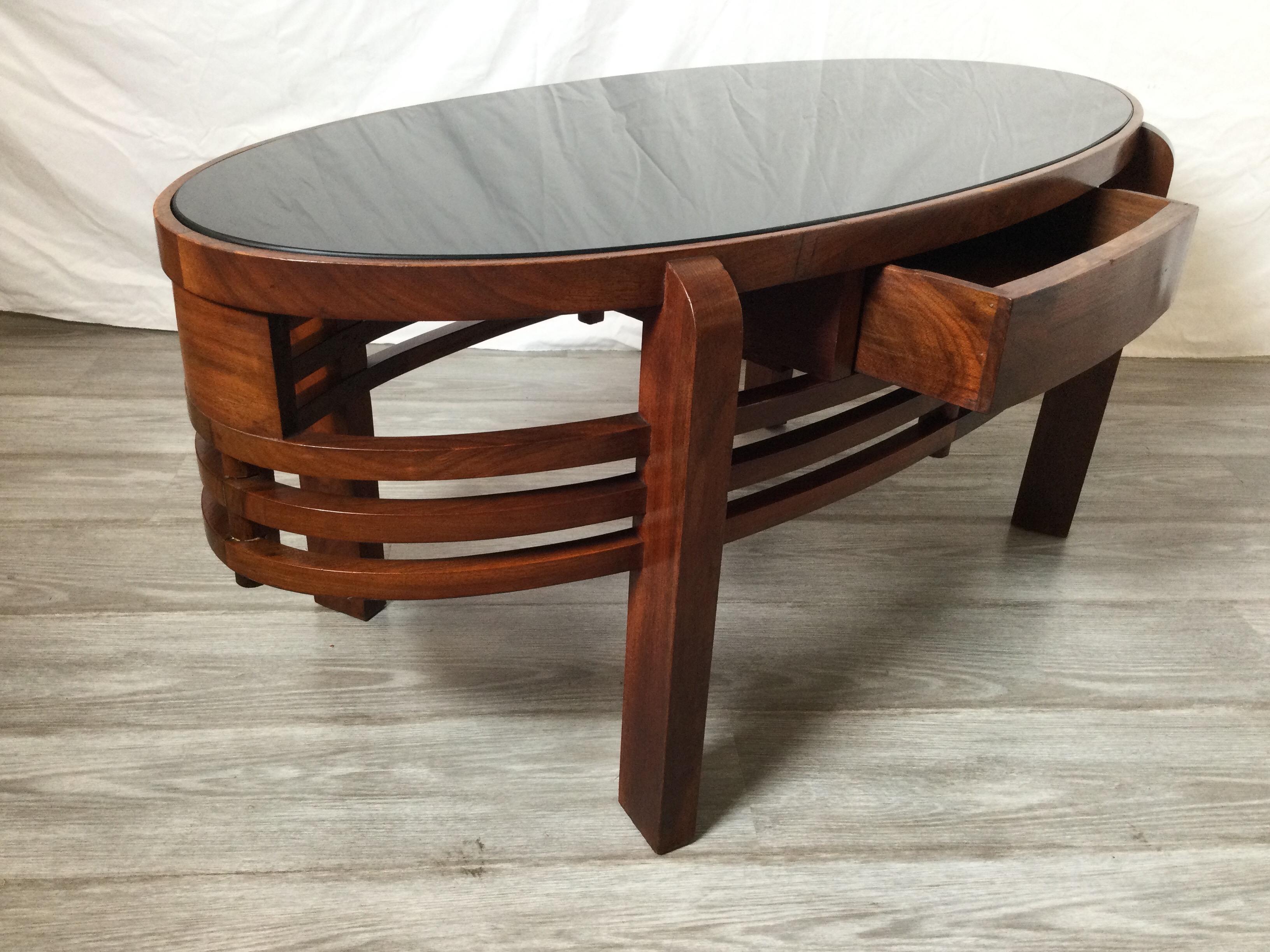 Mid 20th Century Oval Walnut Cocktail Table with Black Glass Top In Good Condition In Lambertville, NJ