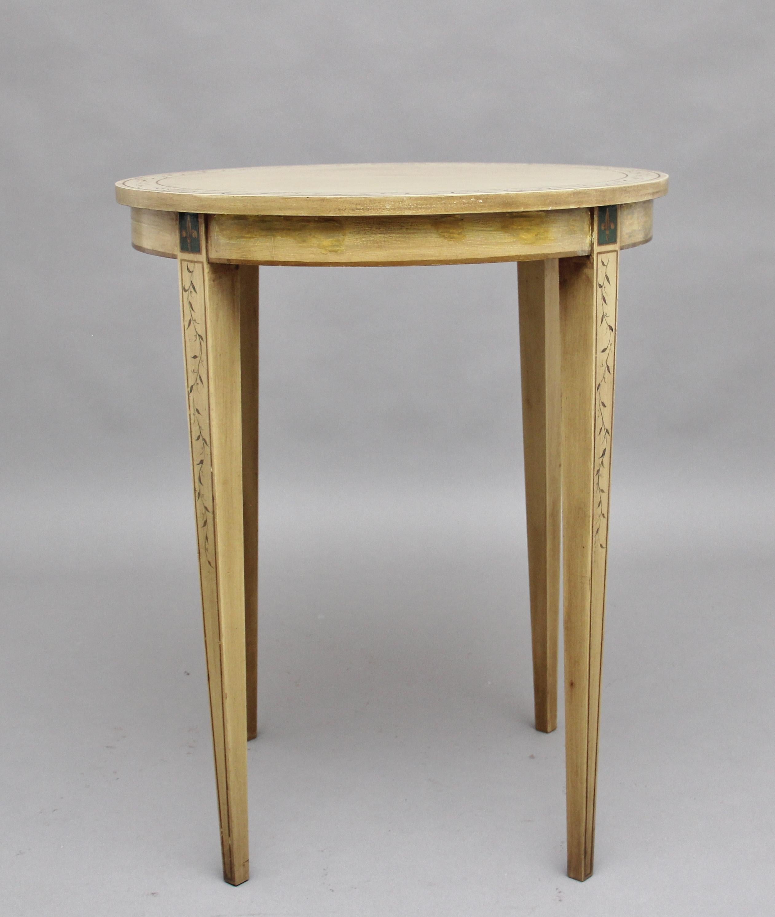 A decorative mid-20th century painted table, the circular top having a boarder decorated with a painted floral design, standing on square tapering legs decorated also with a floral pattern, circa 1960.
       