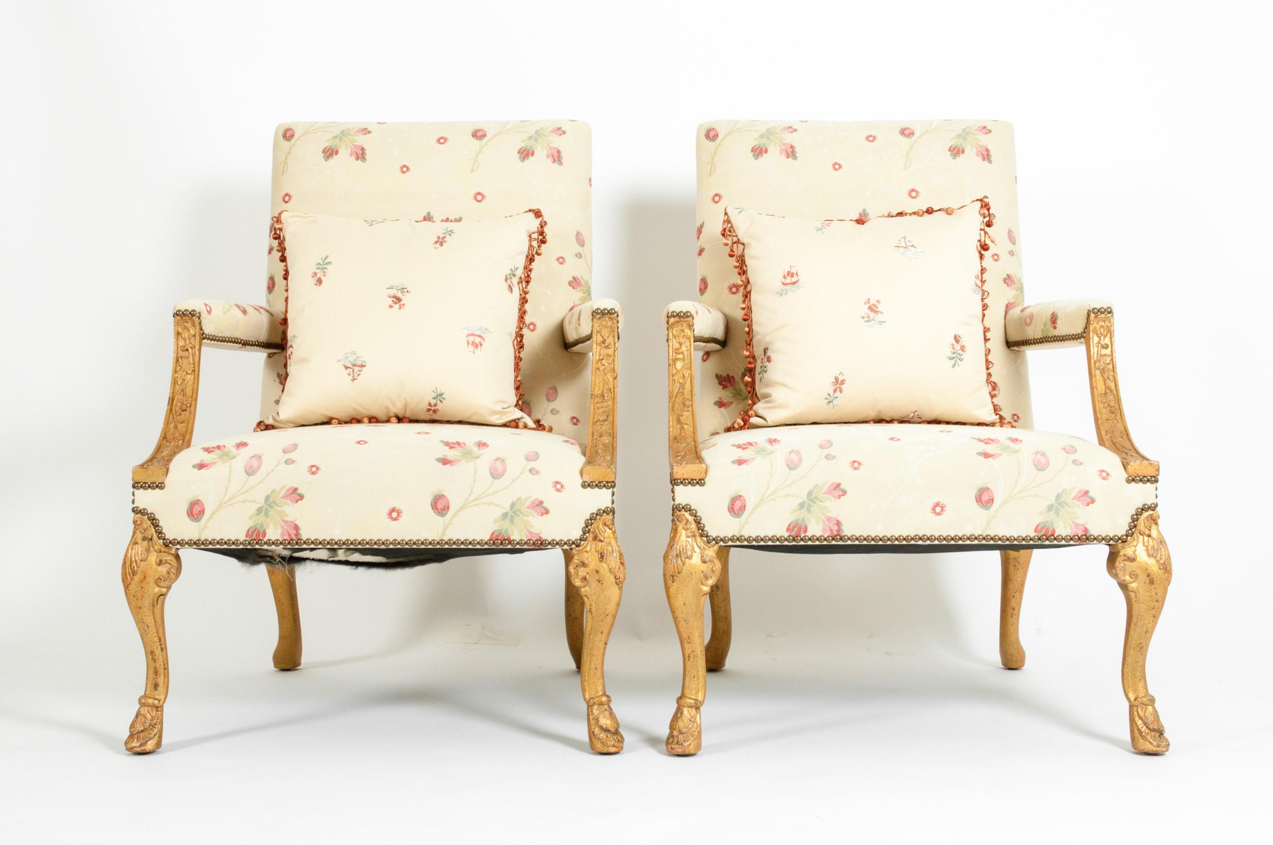 Pair of mid-20th century pair giltwood frame George II style side / library armchairs with square back and vine arms on foliate carved cabriole legs. Each chair is in excellent vintage condition with age / use appropriate wear. The upholstery is